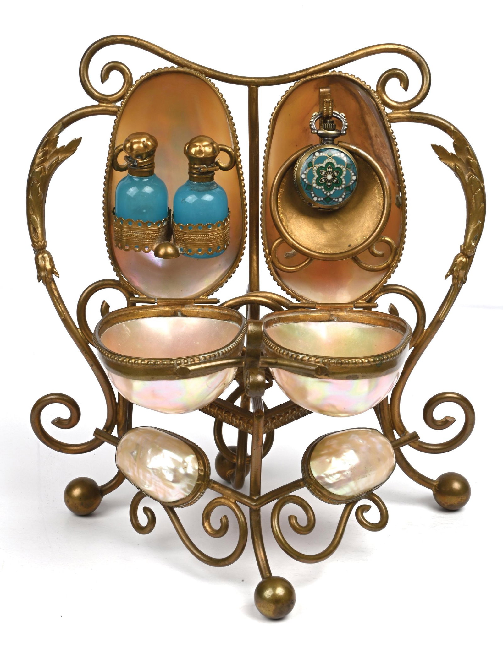 PALAIS ROYAL PERFUME CADDY WITH LARGE MOTHER OF PEARL SHELLS WITH POCKET WATCH AND 2 BLUE PERFUMES: C. 1800s. An attractive French Palais Royal mother-of-pearl perfume caddy on a decorative brass stand. The piece features six mother-of-pearl egg-shaped shells, hinged to open and reveal a timepiece,