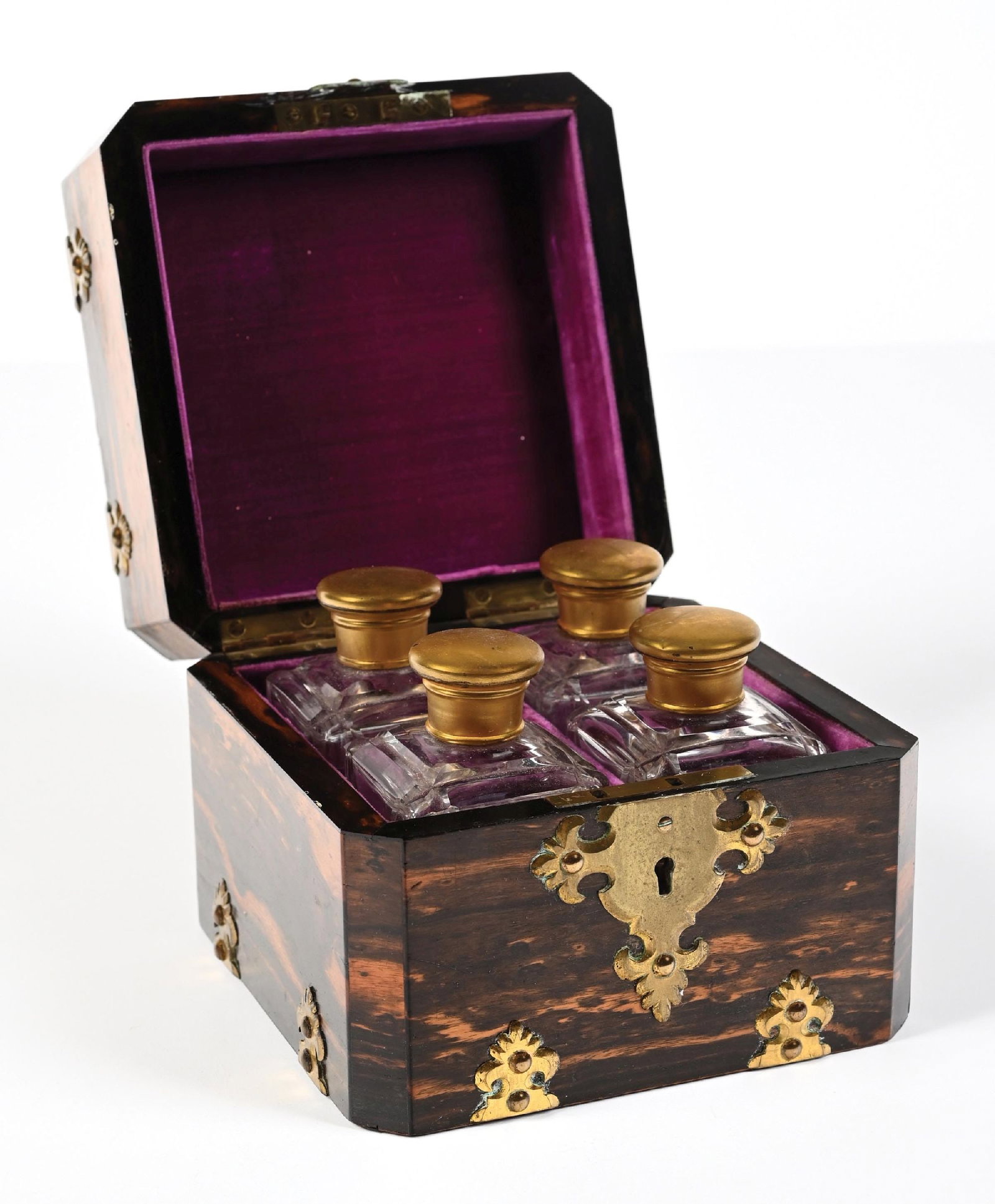 VICTORIAN COROMANDEL WOOD PERFUME BOX & PERFUMES: C. 1860-1880s. A beautiful Coromandel swirl-grain perfume casket featuring a pretty porcelain plaque depicting a cherub resting on a cloud. The box has ornate pierced brass mounts with light patina. T