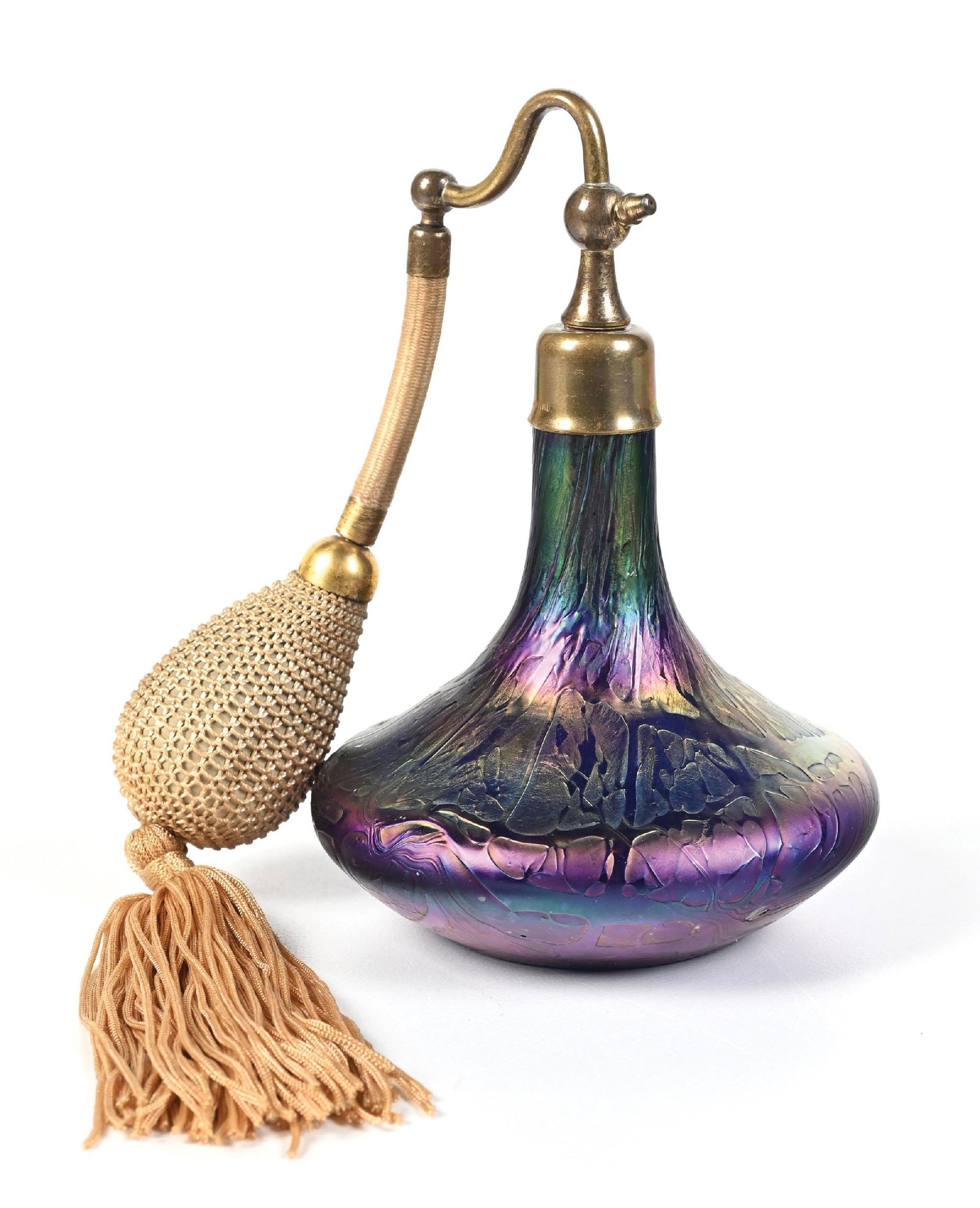 IRIDESCENT LOETZ ART GLASS PERFUME ATOMIZER: C. 1900s. A wonderful Loetz art glass iridescent perfume atomizer and tasseled cream puff. The netted atomizer puff has hardened with age; overall, great condition. 3 - 3/4" x 5 - 1/2". Condition: