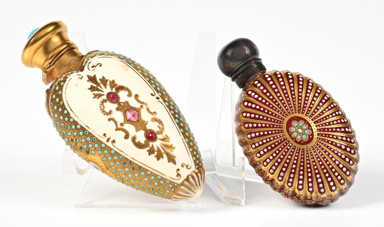LOT OF 2: COALPORT ORNATE & GILDED PERFUME BOTTLES: C. 1800s. (A) A spectacular jeweled Coalport perfume bottle. The bottle features a heart-shaped body of ivory-colored porcelain, decorated with elaborate gold gilding and blue and red jeweled accents,