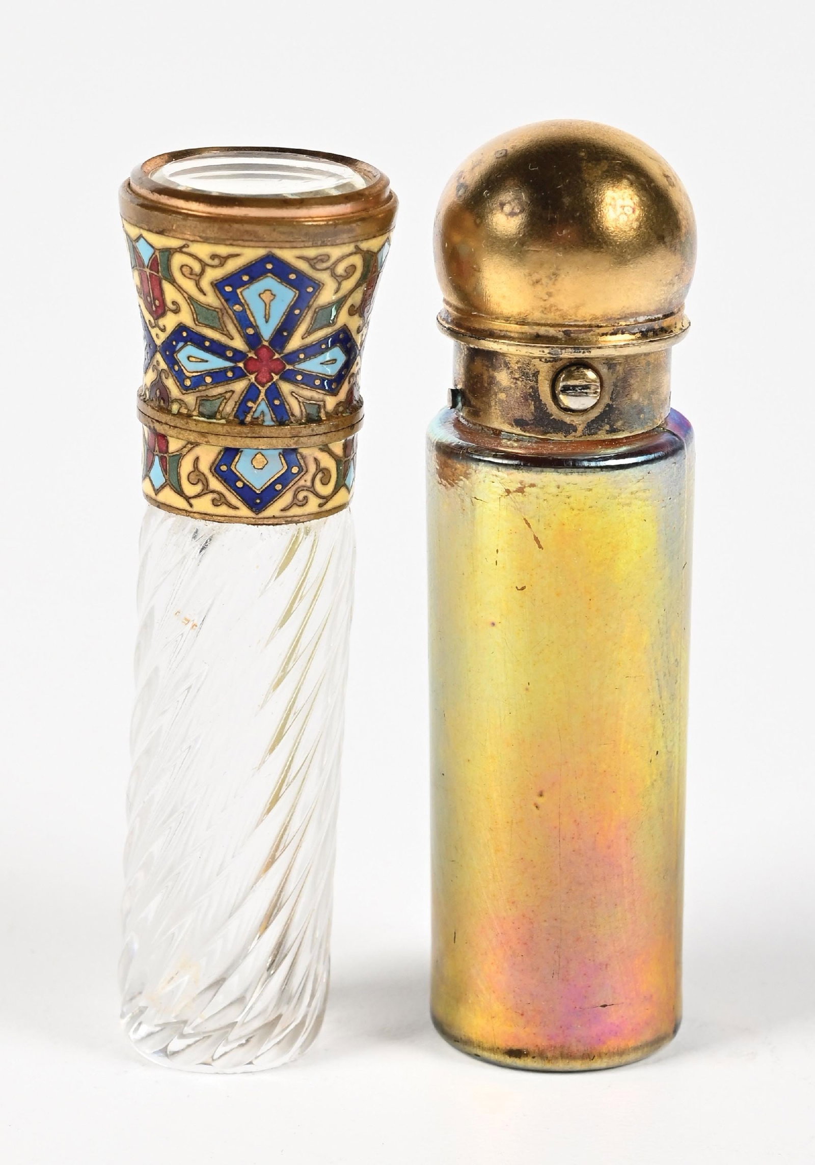 LOT OF 2: ENAMEL CUT GLASS & AURENE PERFUME BOTTLES.: C. 1800s. (A) A ribbed, clear-cut glass perfume with a highly decorative enamel lid featuring a mirror on top. (B) A Samson Mordan gold aurene perfume, signed MORDAN & Co., has some patina, the glass 