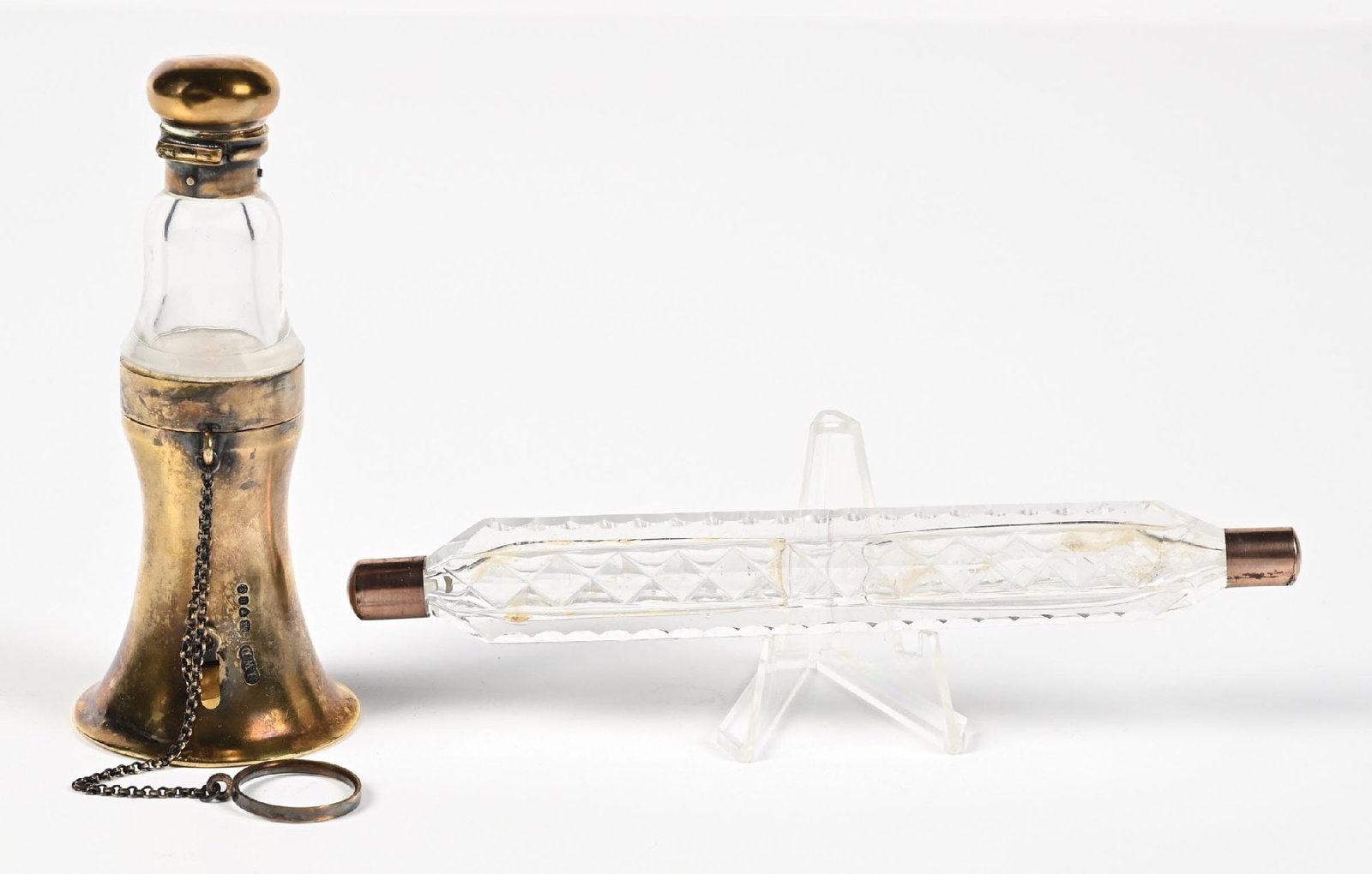 LOT OF 2: CLEAR CUT GLASS PERFUME BOTTLES: C. 1800s. (A) A silver-gilt (stamped) combined vinaigrette, perfume, and posy holder, with a mechanical hinged lid. All of which are in magnificent condition—subtle patina. A very interesting an