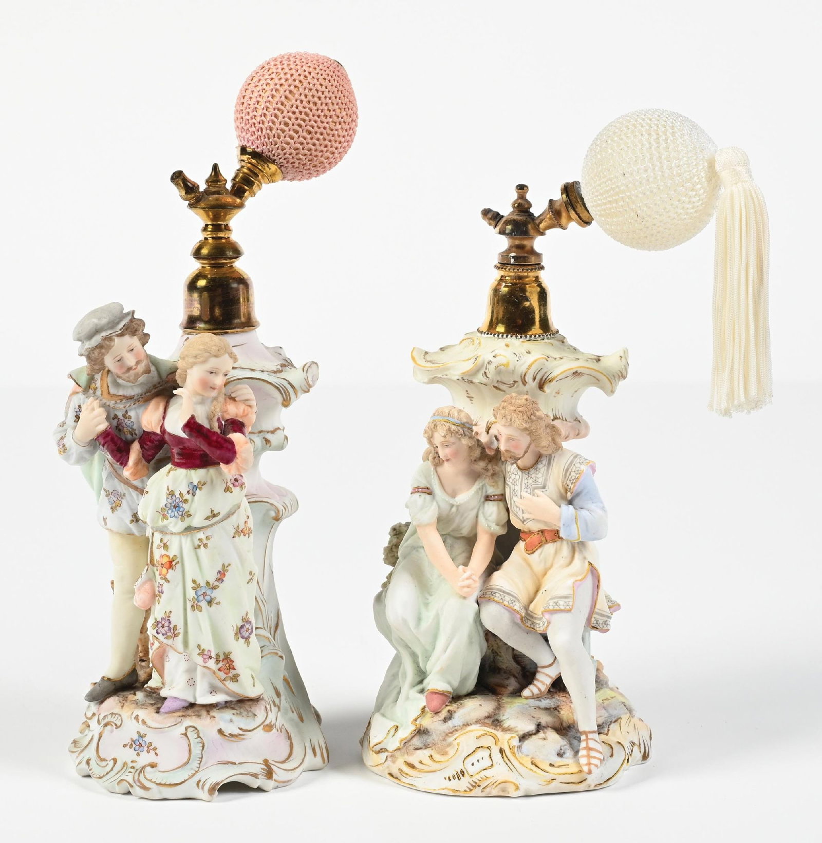LOT OF 2: AELTESTE VOLKSTEDT BISQUE FIGURAL PERFUME ATOMIZERS: C. 1894-1900s. (A) A magnificent Aelteste Volkstedt bisque porcelain figural atomizer perfume. The perfume features an endearing couple. The perfume has a few minor chips and minor paint chips. The pe