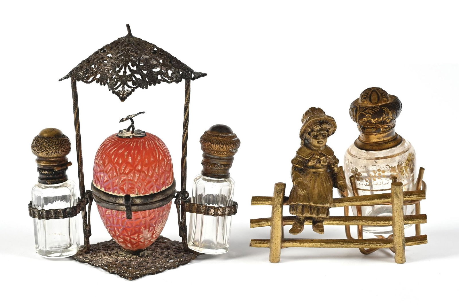 LOT OF 2: GIRL ON FENCE & STRAWBERRY SHAPED PERFUME BOTTLE STANDS: C. 1800s-1900s. (A) A stunning French Palais Royal scent caddy with an intricate, ornate patinated brass frame. The central component features a red strawberry-shaped container with geometric patterns