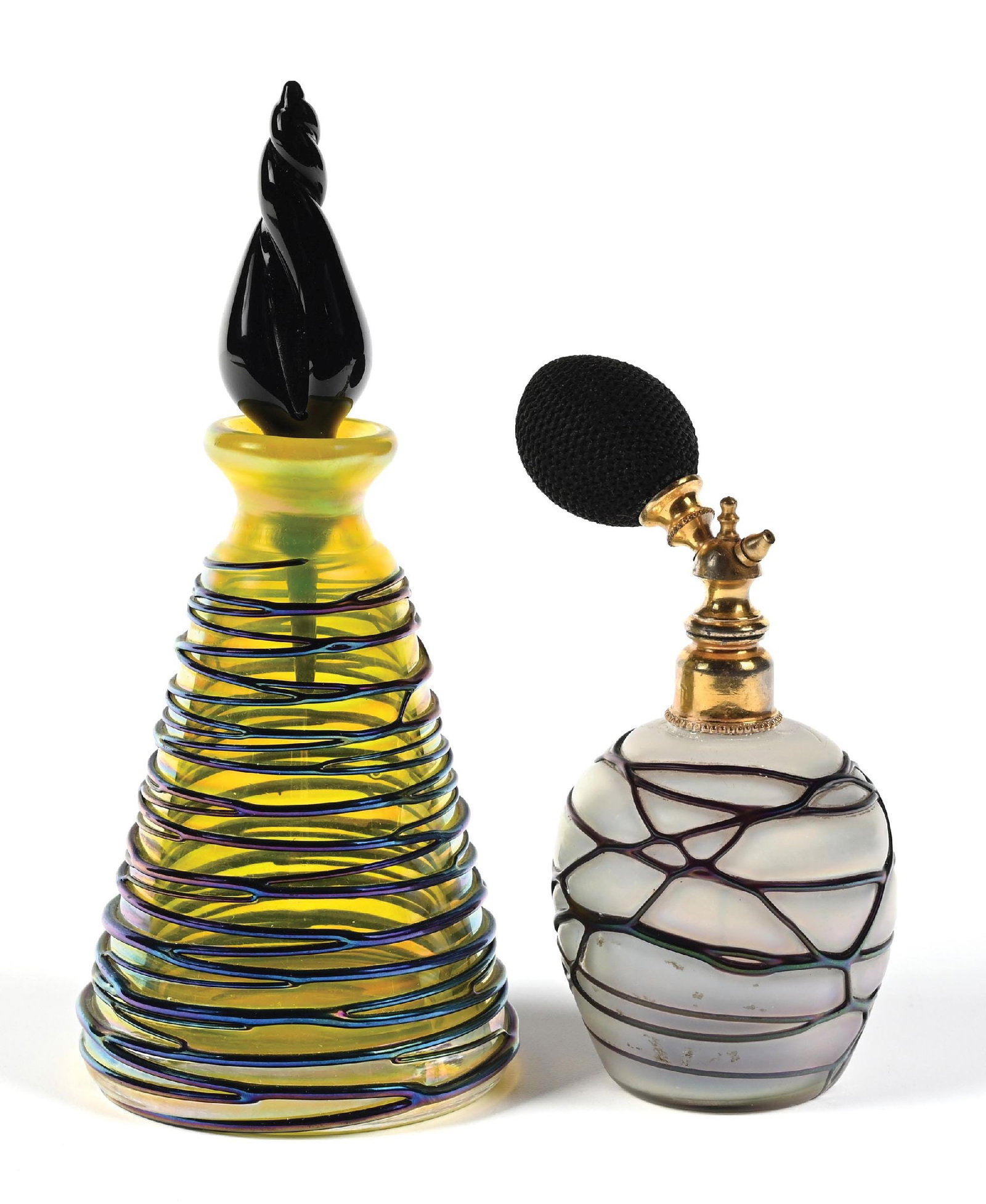 LOT OF 2: ART GLASS AURENE RAINBOW IRIDESCENT PERFUMES WITH SWIRL PATTERNS: C. 1900. (A) A cheerful hand-blown art glass swirled aurene rainbow iridescent perfume bottle, featuring a yellow glass body with a dimensional hand-swirled iridescent glass threaded applique on the o