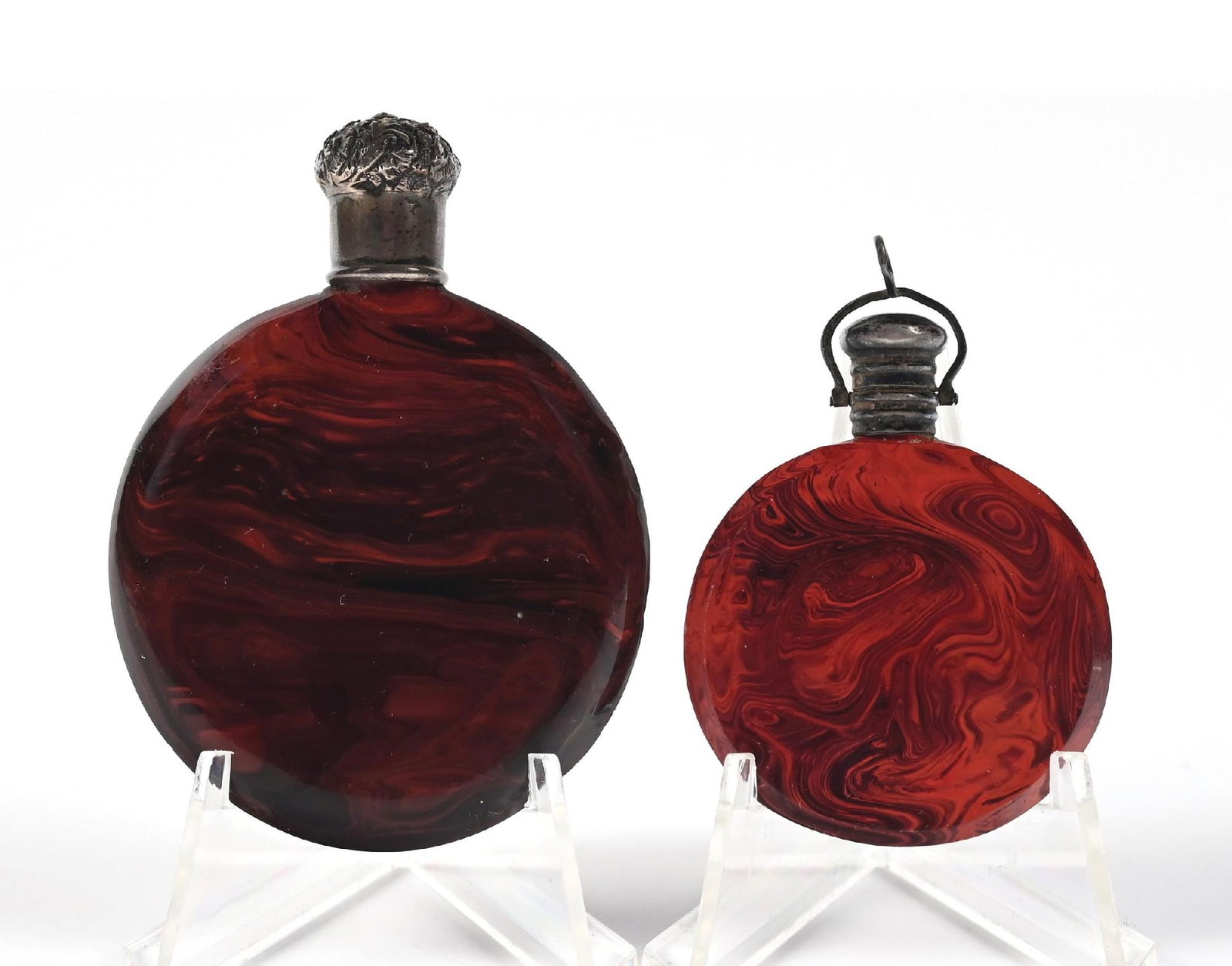 LOT OF 2: SMALL RED LITHYALIN PERFUME BOTTLES: C. 1800s. A collection of two red and maroon flat-lay Lithyalin glass perfumes with ornate silver lids, in great condition. Largest: 1 - 3/4" x 2 - 1/2". Condition: 200 Dimensions: (Excellent).
