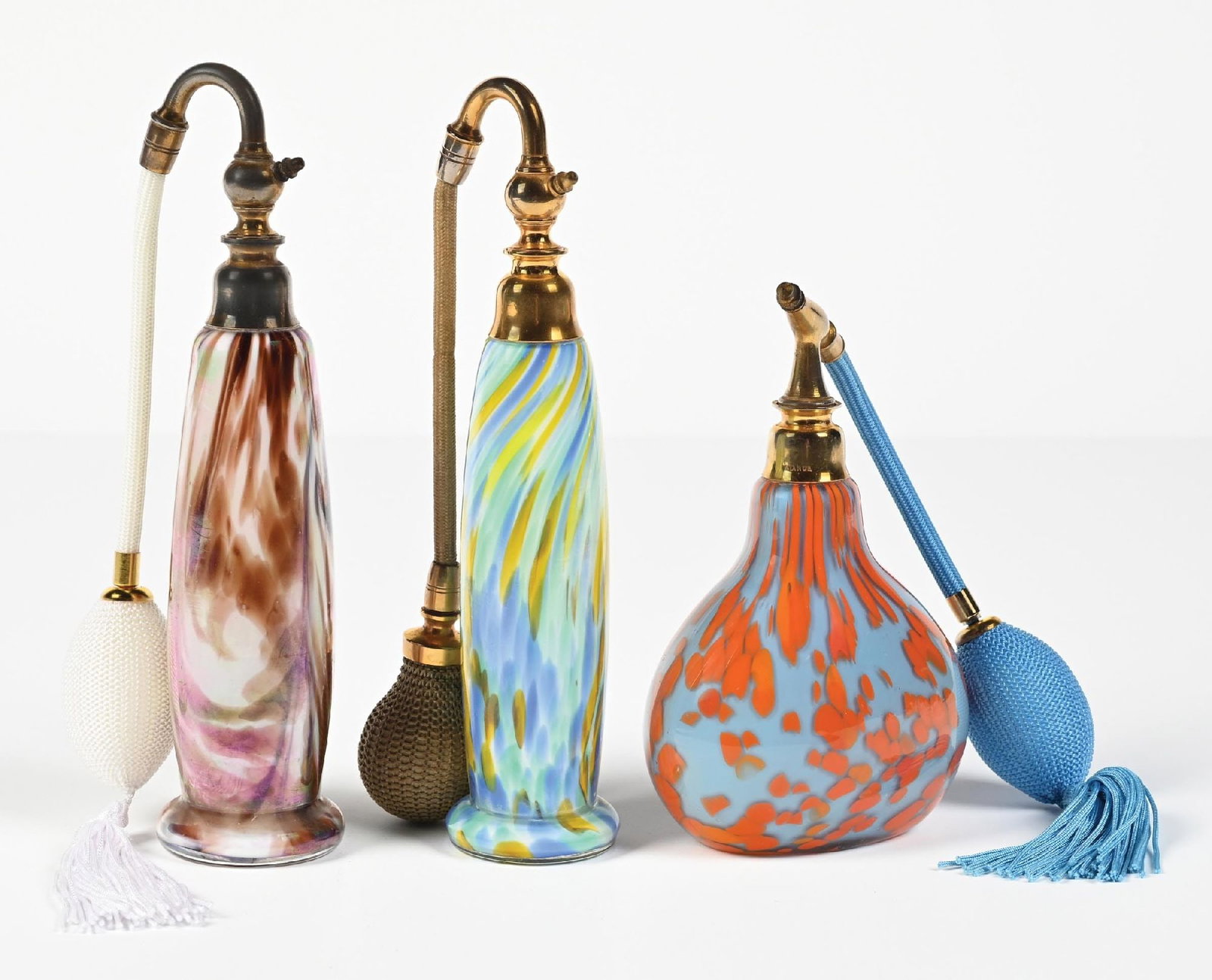 LOT OF 3: HAND-BLOWN ART GLASS CZECH PERFUME ATOMIZERS: C. 1920s. (A) A phenomenal iridescent brown and white marbled perfume atomizer with gold-metal atomizer and includes a functional white fabric atomizer puff. In stunning condition. (B) A wonderful, vi