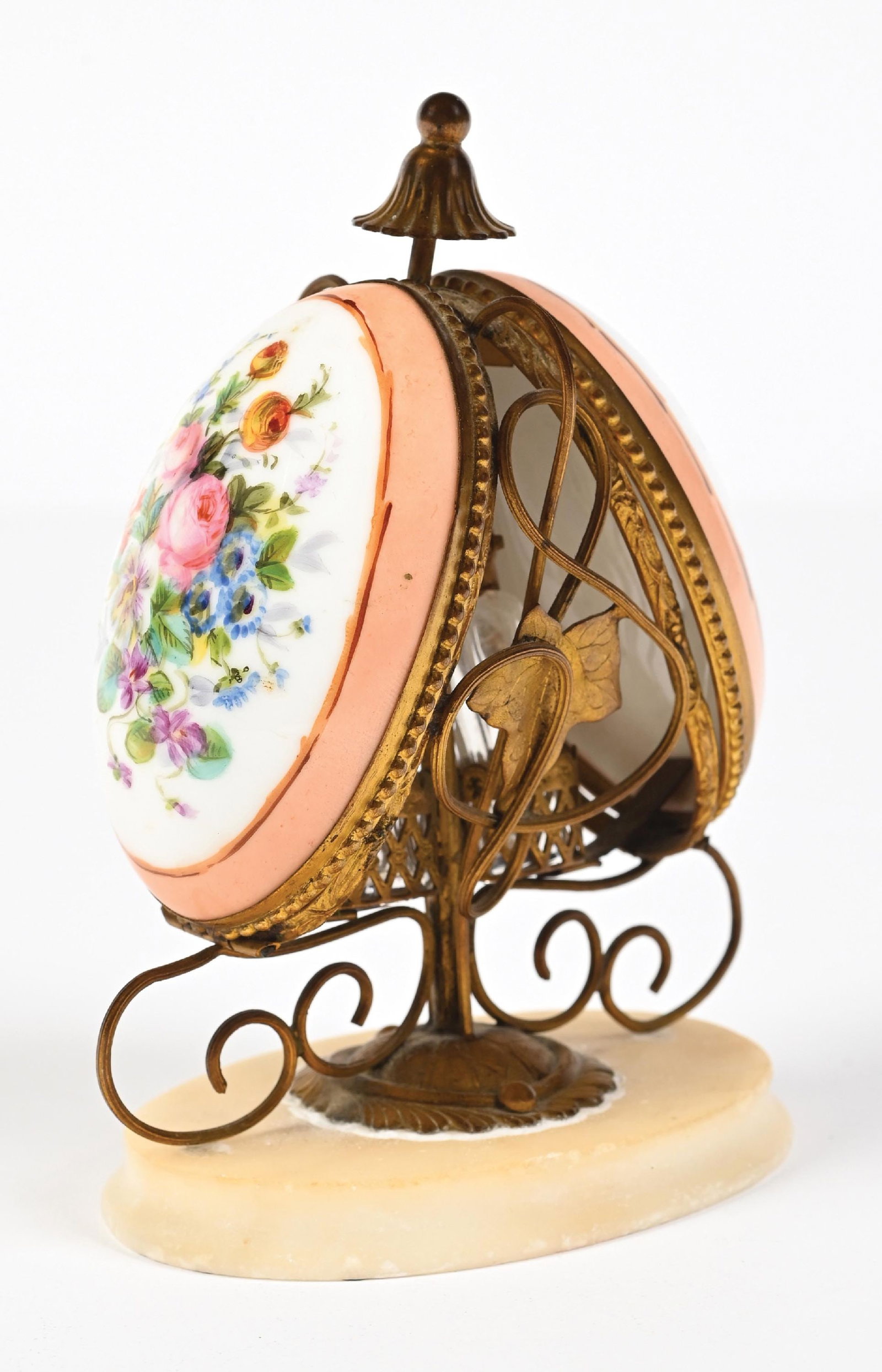 PORCELAIN EGG SHAPED PERFUME CADDY WITH 2 PERFUMES: C. 1800s. A stunning French Palais Royal scent caddy featuring an egg-shaped porcelain container with floral patterns that, at the push of a button, opens to reveal a gilt ormolu stand featuring two