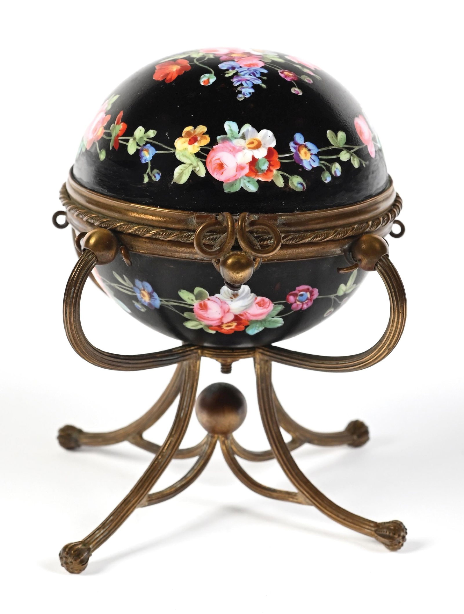 BLACK FLORAL PORCELAIN PERFUME CADDY WITH 3 PERFUMES: C. 1800s. A fantastic Palais Royal perfume caddy featuring a black, globe-like porcelain body, decorated with vibrant, raised enamel floral patterns, and held and framed by four ornate brass legs. Ins