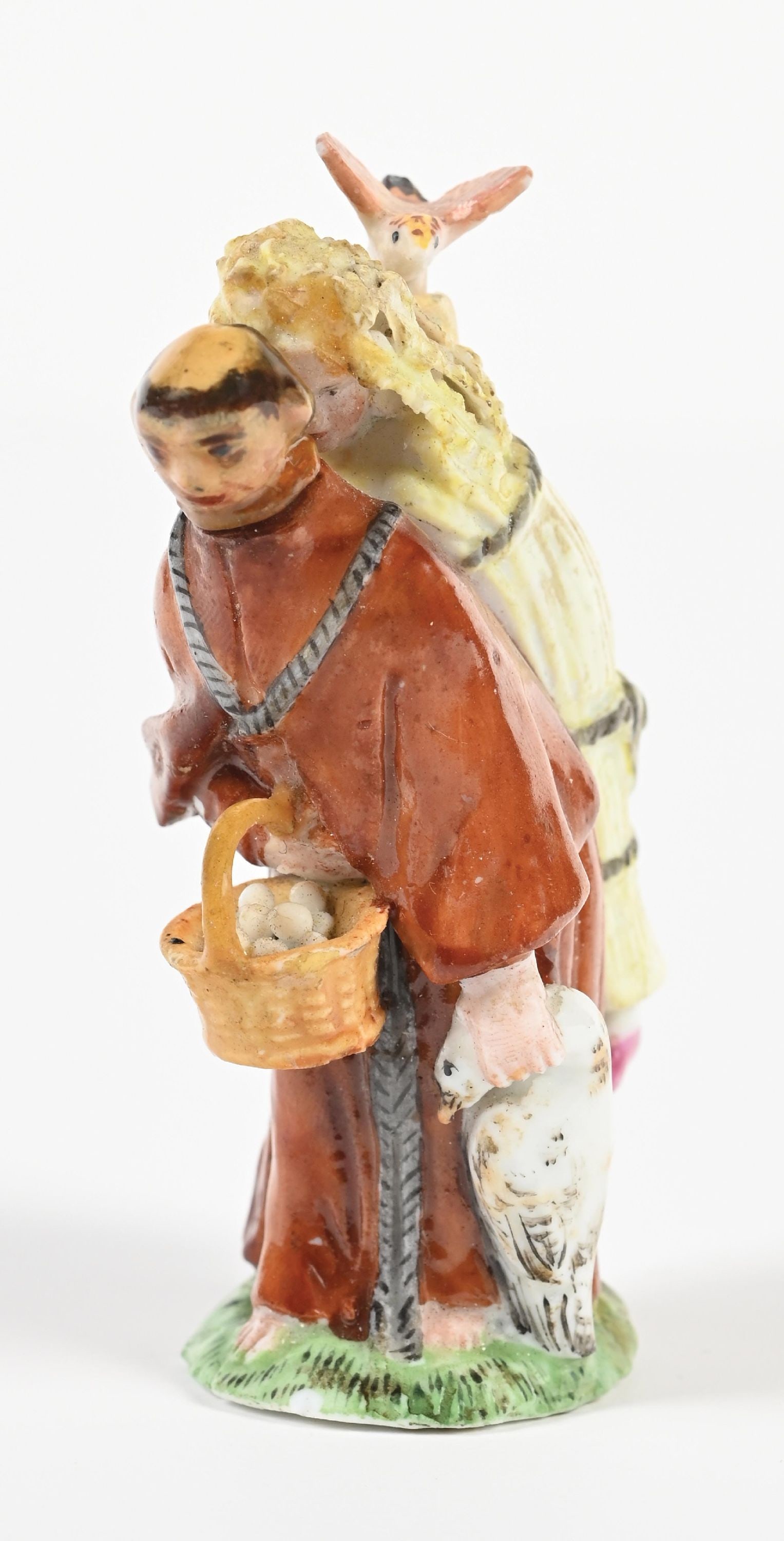 MEISSEN MONK PERFUME: C. 1890s. (A) A nicely executed Meissen porcelain double-scent perfume depicting a monk carrying a woman and grain. The crossed swords mark is present but appears blurred; the number