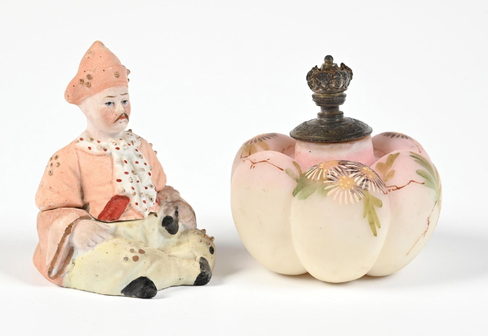 LOT OF 2: PORCELAIN FIGURAL PERFUME BOTTLES: C. 1800s. (A) A bisque porcelain sitting monk perfume in good condition, gently showing signs of age. (B) A Burmese porcelain perfume with silver-toned metal cork-top lid, while the body features