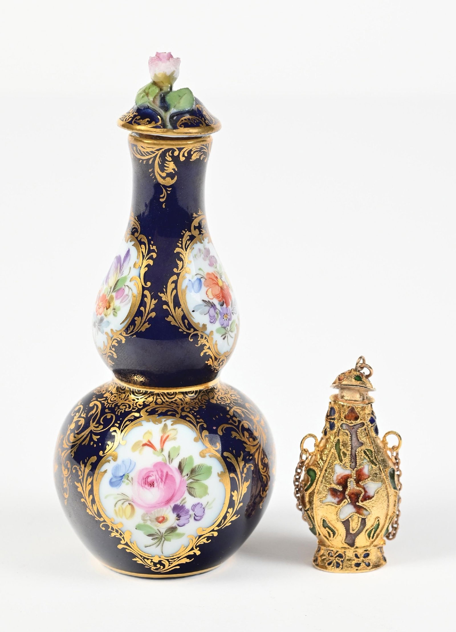 LOT OF 2: PORCELAIN COBALT BLUE PERFUME BOTTLE & GOLD FLORAL MINIATURE PERFUME CHARM: C. 1800s. (A) A Meissen porcelain perfume bottle with hand-painted gold-tone and intricate floral patterning and scrollwork, in great condition. (B) A gold-toned metal châtelaine perfume bottle w