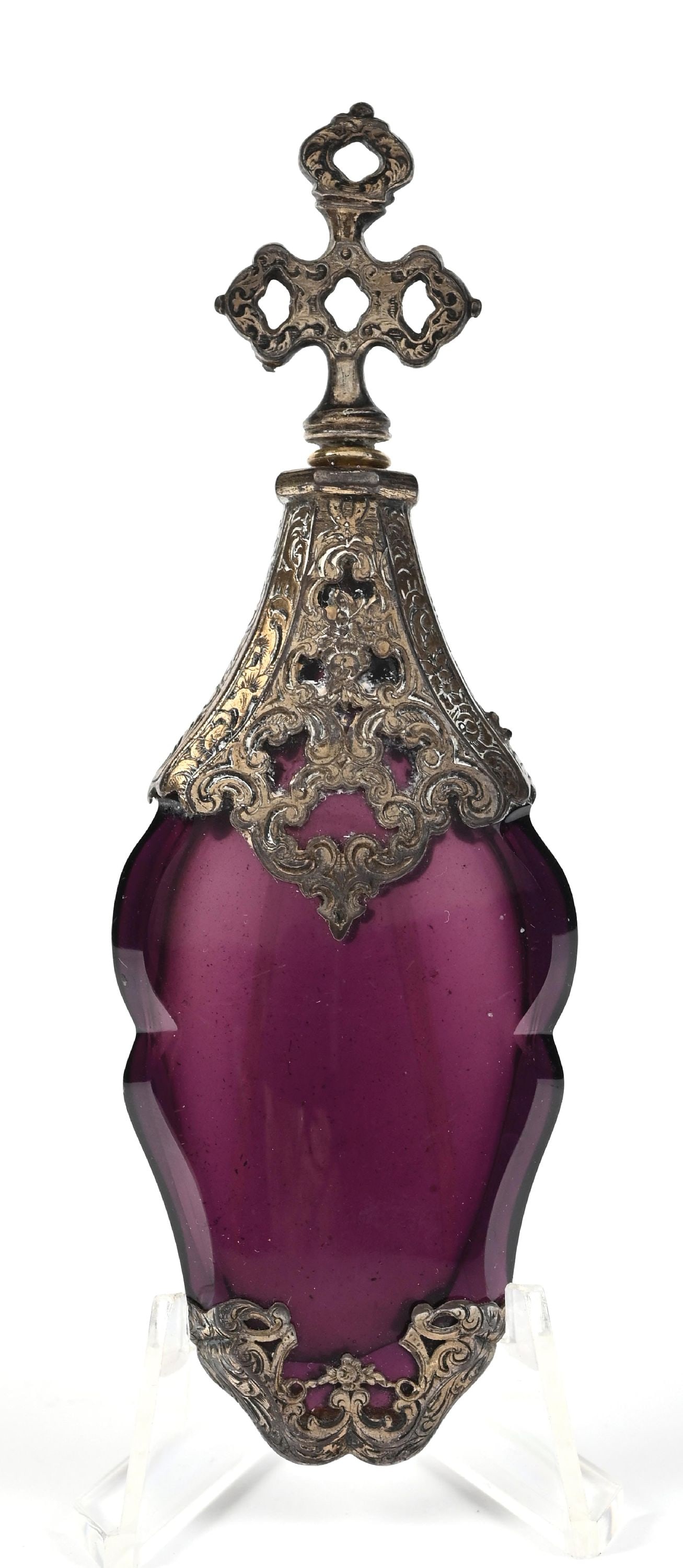 FRENCH DARK PURPLE GLASS PERFUME BOTTLE WITH OVERLAY: C. 1800s. A purple pressed glass flat-lay perfume featuring a silver ornate overlay with patina and a final reminiscent of a cross. The perfume is in outstanding condition, with anticipated age. 1 - 1