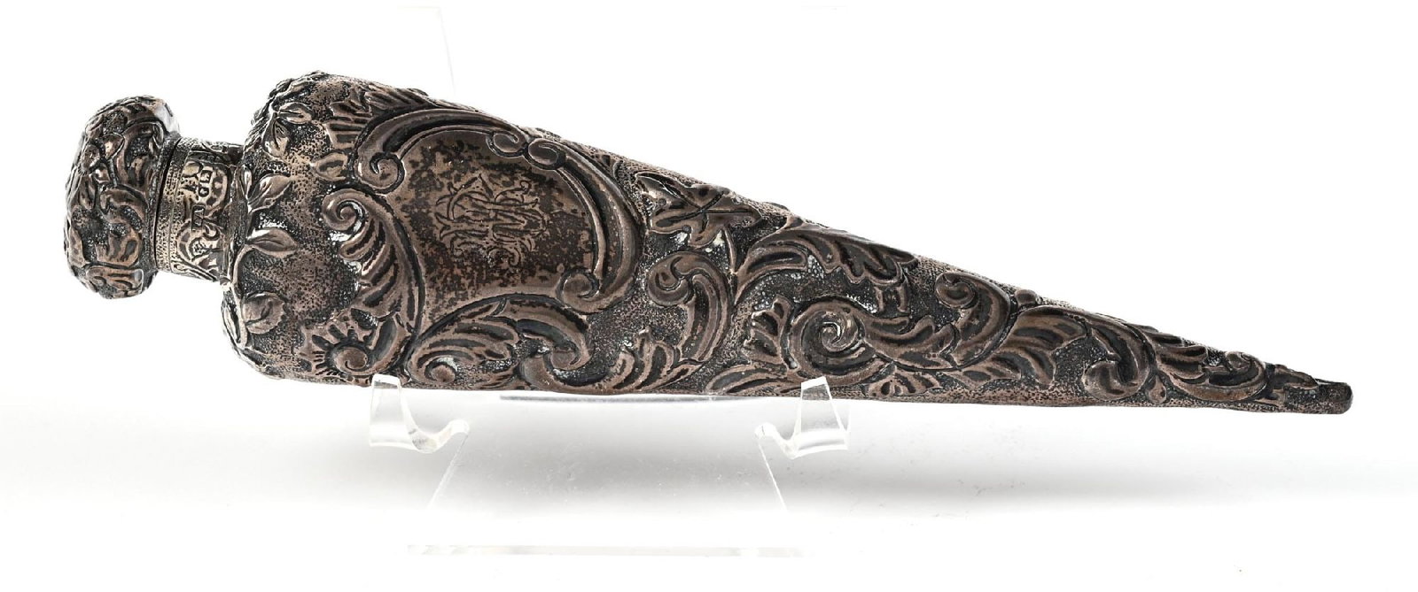 VICTORIAN SILVER TAPERING PERFUME BOTTLE: C. 1800s. A lovely silver (1888 HNA English Gothic silver) laydown scent bottle, the surface is decorated with an intricate patinaed repousse-textured floral pattern, with a matching decorative hinged