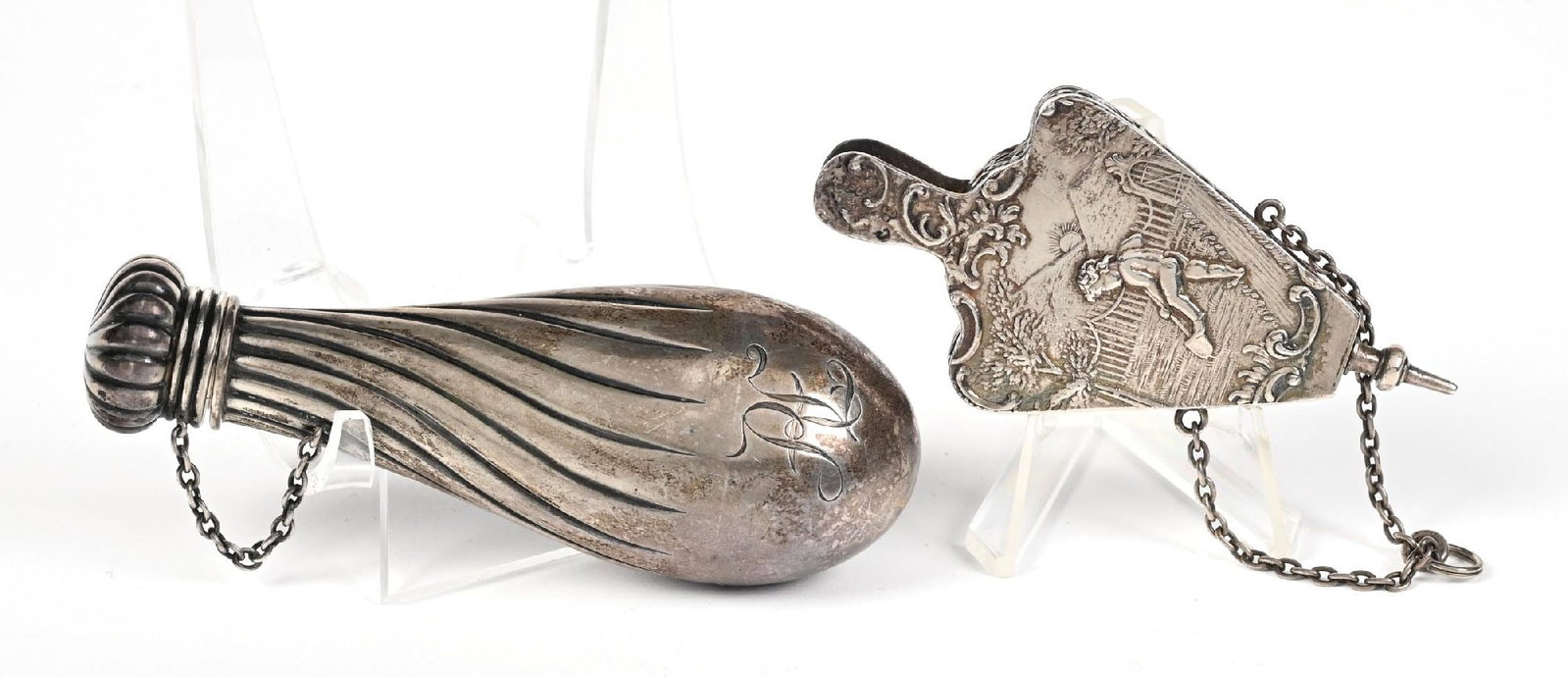 LOT OF 2: SILVER PERFUME BOTTLES: C. 1800s. A beautiful pair of highly ornate Victorian sterling silver bottles, featuring intricate decorative detailing and rich character. Both pieces display a natural patina that highlights their a