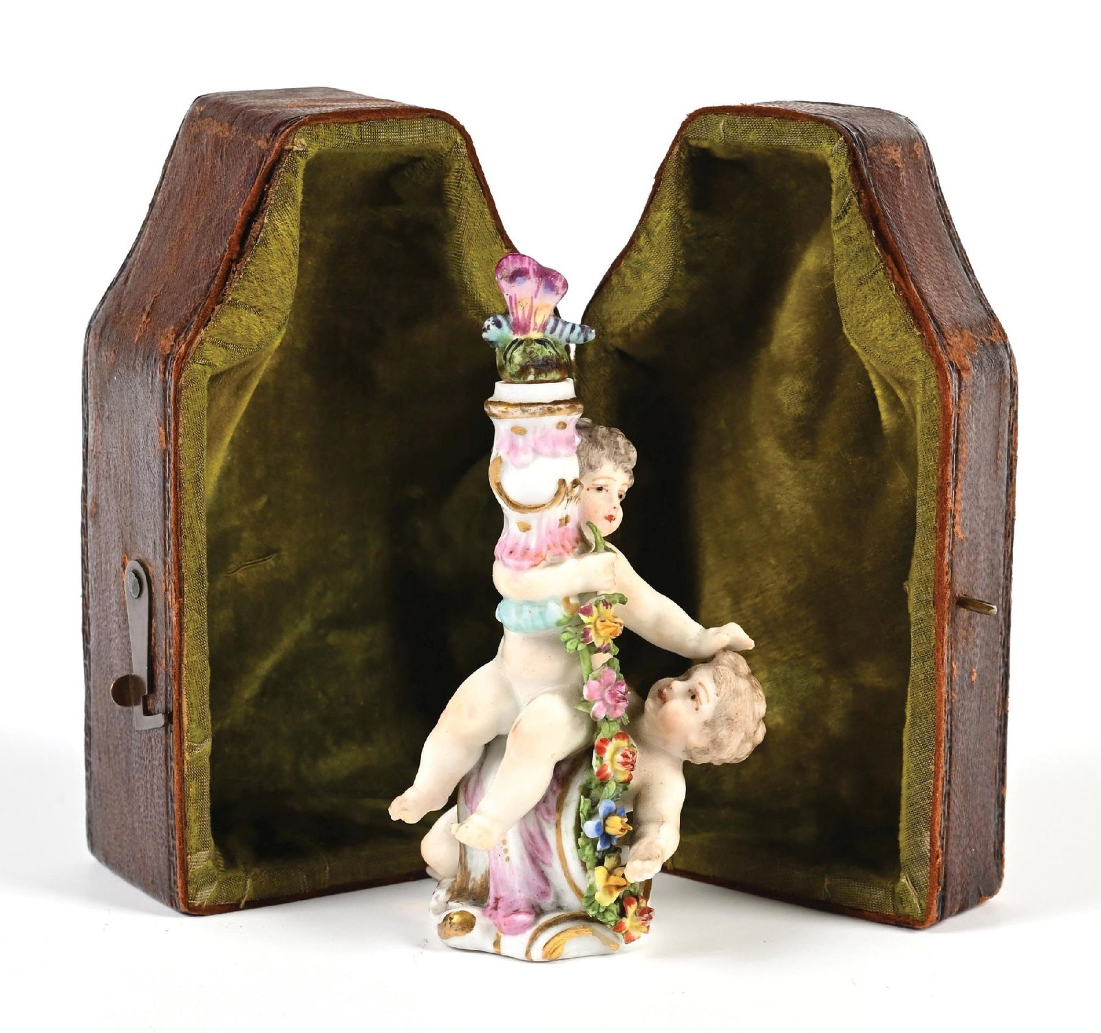 FASOLD & STAUCH PERFUME FIGURAL IN ORIGINAL CASE: C. 1800s. Fasold & Stauch perfume figural with its original leather case depicting small children playing in floral settings, the case shows age but features a beautiful green velvet interior. The per