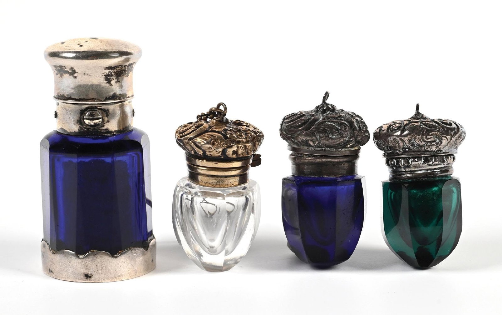 LOT OF 4: MINIATURE GLASS VINAIGRETTE BOTTLES: C.1800s. Group of four cut glass vinaigrette bottles, including a combination scent and vinaigrette cobalt blue example with faceted octagonal body fitted with a gilt metal mount, hinged cap, and scal