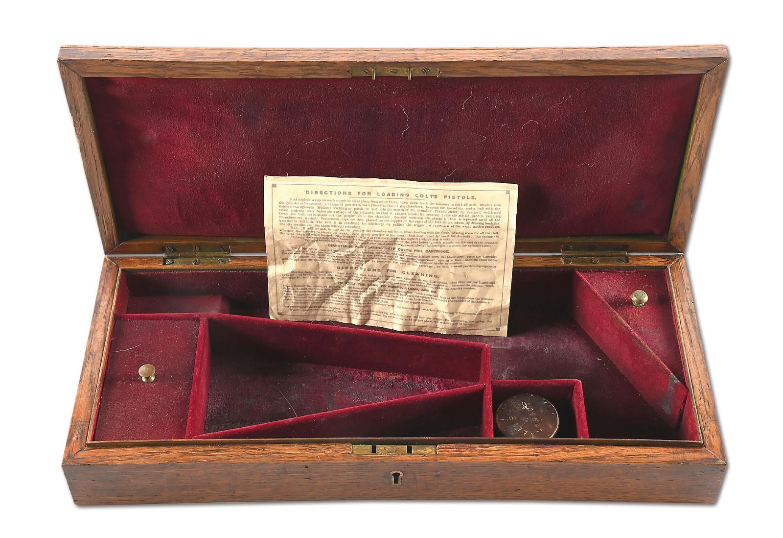 ORIGINAL COLT MODEL 1860 ARMY PERCUSSION REVOLVER DISPLAY CASE: The lid has a large shield type escutcheon set in at top and no brass screws. Case is partitioned for the standard 8" revolver and accessories. It is lined in a deep dark blood red. It comes with an o