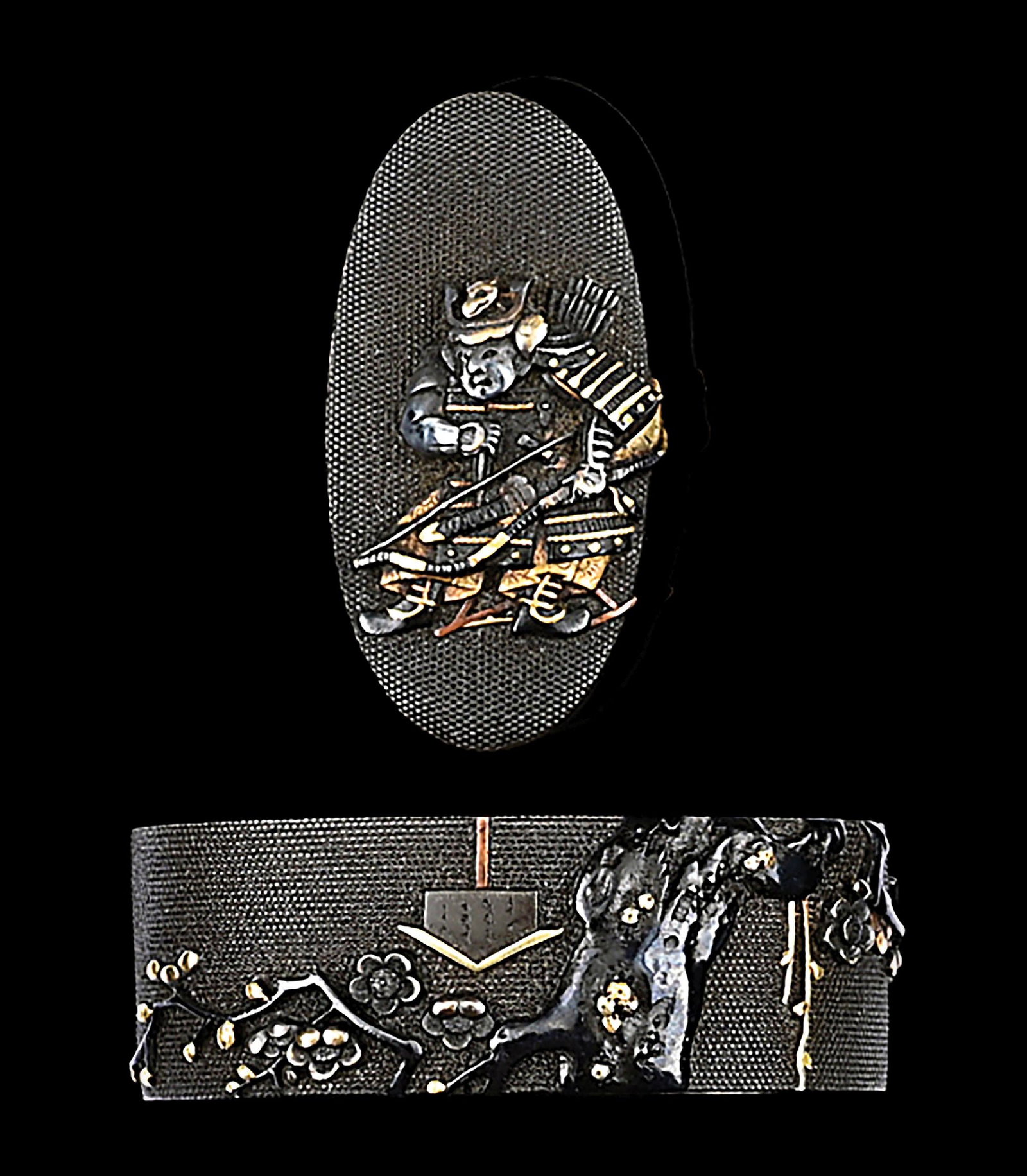 FUCHI KASHIRA SIGNED MASATSUNE WITH DESIGNS OF PLUM TREE AND SAMURAI: Signed "Masatsune (Kao)" on fuchi. The fuchi on a shakudo base with a fine nanako ground with a carved relief of a plum tree overhanging a sign, accented with gold. Measures 3.7cm x 2.2cm x 1.3cm. The