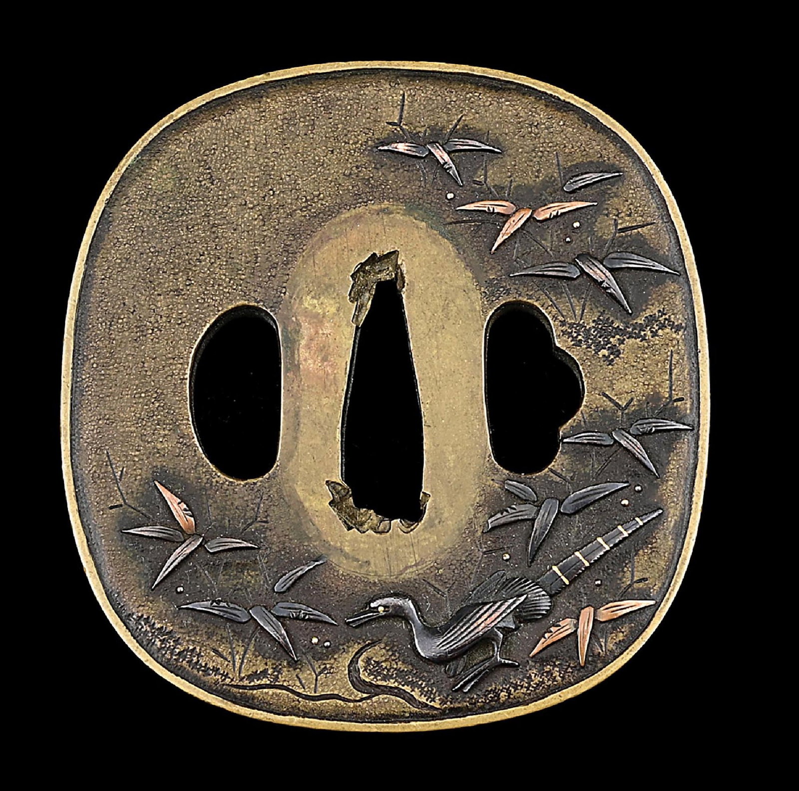 AN EDO PERIOD TSUBA DEPICTING A PEACOCK: Of brass construction with a an applied brass rim about the perimeter referred to as a fukurin. Open hitsu-ana, with designs of a peacock in a floral scene on a textured ishemi ground. Peacocks were s