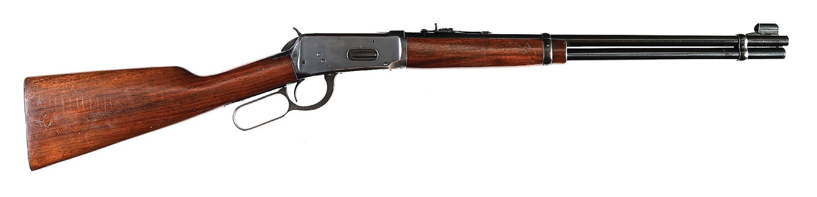(C) PRE-1964 WINCHESTER MODEL 1894 LEVER ACTION CARBINE (1955).: Dates to 1955. Standard carbine with blue finish, full length magazine tube, hooded ramp front sight, semi buckhorn rear sight, walnut stock without comb flutes, a checkered metal butt plate, and