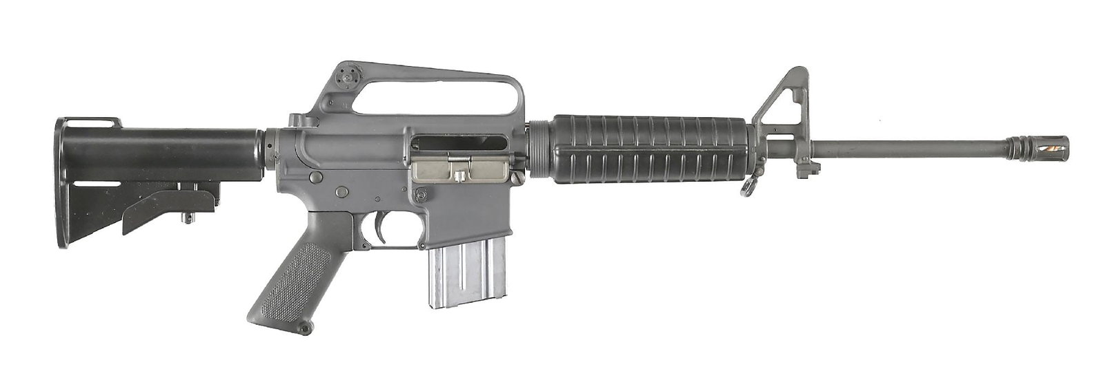 (M) COLT SP1 AR-15 SEMI-AUTOMATIC CARBINE WITH BOX (1979).: This early SP1 carbine was manufactured in 1979. The carbine length pencil barrel is marked "C MP B" on the underside and is fitted with a bird cage flash hider. Protected post front sight on a triang