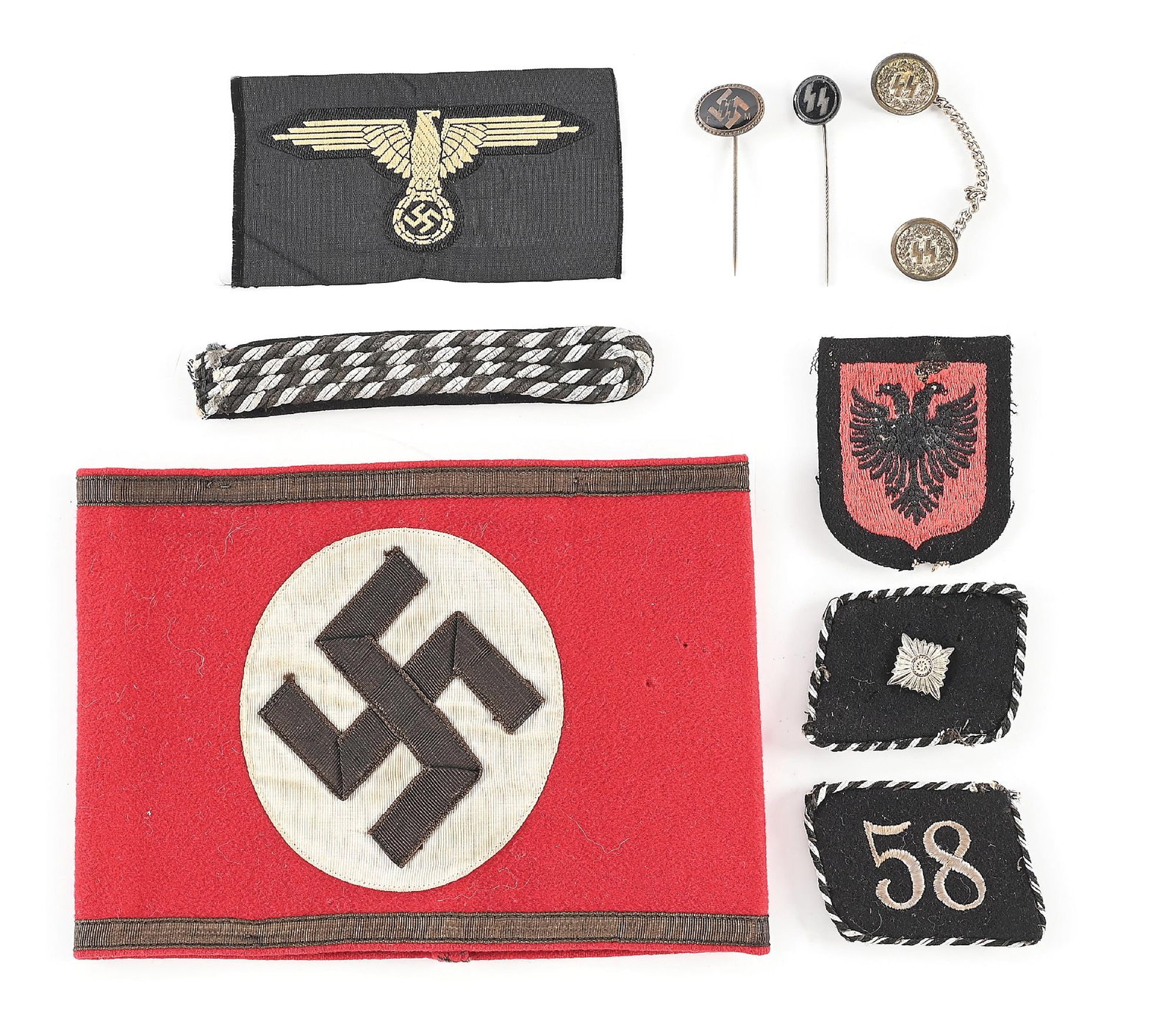 LOT OF THIRD REICH SS INSIGNIA.: Lot of Third Reich SS insignia. Lot includes a SS armband with RZM tag, Bevo SS sleeve eagle with RZM tag, stickpins, collar tabs, etc. CONDITION: Overall very good to excellent.