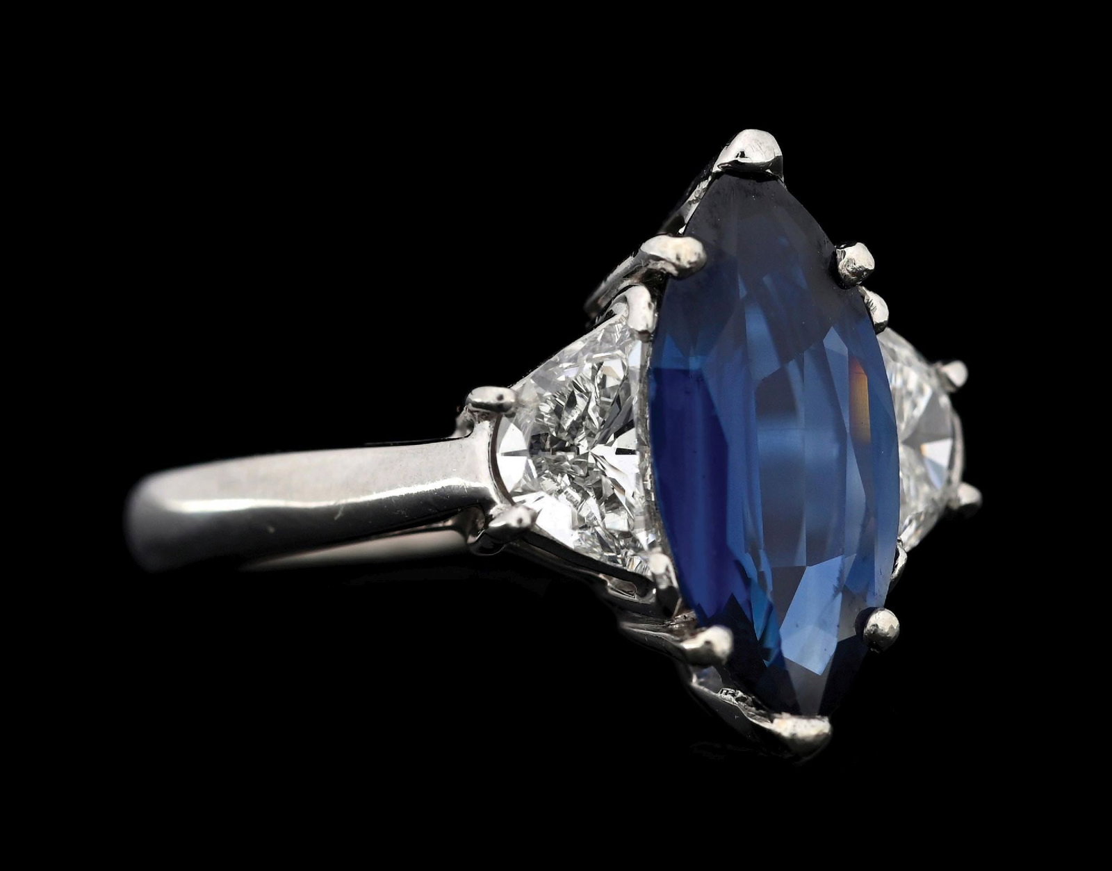 PLATINUM SAPPHIRE & DIAMOND RING W/GIA REPORT: Platinum sapphire and diamond ring consisting of 1 marquise cut blue sapphire weighing 2.50cts and 2 half moon cut near colorless natural diamonds with a total weight of 1.00cts. Ring is accompanied b
