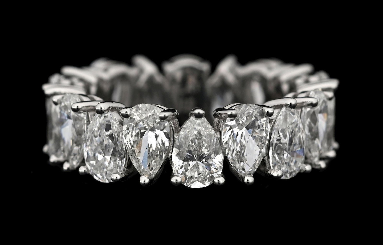 PLATINUM PEAR SHAPE DIAMOND ETERNITY BAND, 5.82CT TW: Platinum diamond eternity band consisting of 18 pear shape near-colorless natural diamonds with a total weight of 5.82cts. Width measures 6.5mm. Finger size 6-1/4. Gross weight is 7.0 grams. Marked "P