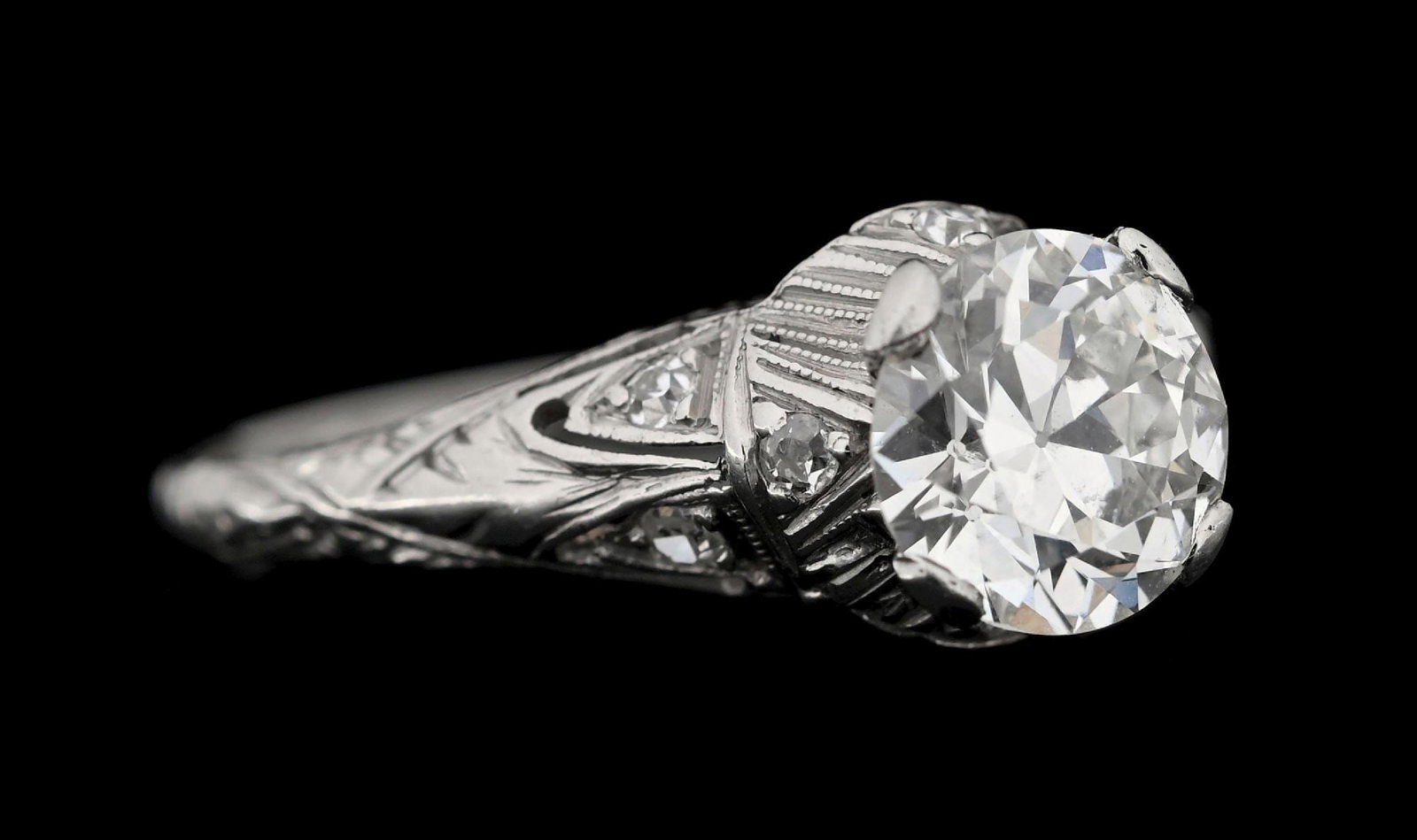 PLATINUM OLD EUROPEAN DIAMOND ART DECO FILAGREE RING W/REPORT: Platinum art deco filigree diamond engagement ring consisting of 1 old European round cut natural diamond weighing 1.10cts, graded G/H color, VS1 clarity, and 8 single cut round diamonds with a total 