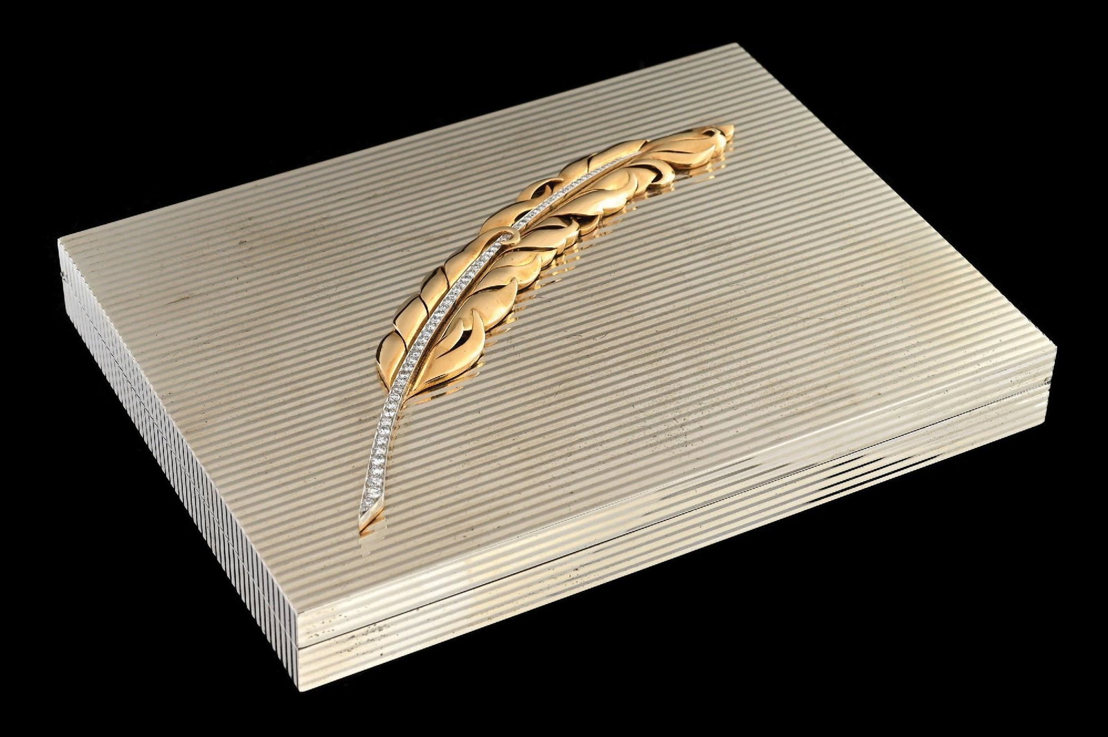BVLGARI SILVER MINAUDIERE WITH GOLD & DIAMOND FEATHER & ORIGINAL CASE: Bulgari Art Deco Minaudière made in solid sterling silver decorated with a yellow gold feather having a line of 65 graduated round brilliant cut diamonds set in either white gold or silver. Circa