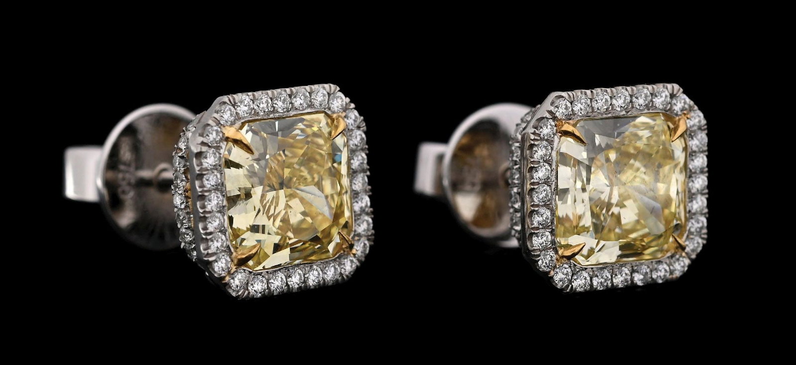 18K WHITE GOLD 5.67CT TW FANCY YELLOW DIAMOND EARRINGS W/GIA REPORTS: 18k white and yellow gold fancy yellow diamond (2 radiants @ 4.47ctw) and diamond (120 rounds @ 1.20ctw) earrings accompanied by two original GIA colored diamond grading reports. (See additional websi