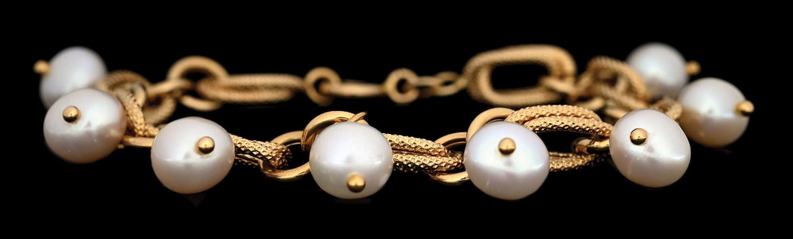 18K YELLOW GOLD 8" CULTURED PEARL BRACELET: 18k yellow gold pearl bracelet consisting of 8 drilled cultured pearls measuring approximately 10mm each. Length measures 8". Width measures 10mm. Gross weight is 25.0 grams. Marked "750". Condition: 