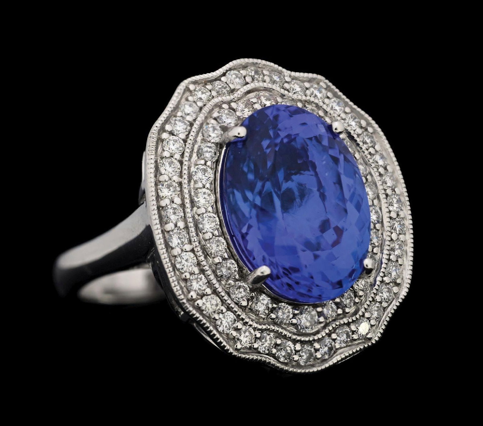 PLATINUM TANZANITE & DIAMOND RING W/GIA REPORT: Platinum tanzanite (7.97ct) and diamond (0.85ctw) ring accompanied by an original GIA identification report and a GGA appraisal report with an ERRV of $36,790.00. (See additional website images for re