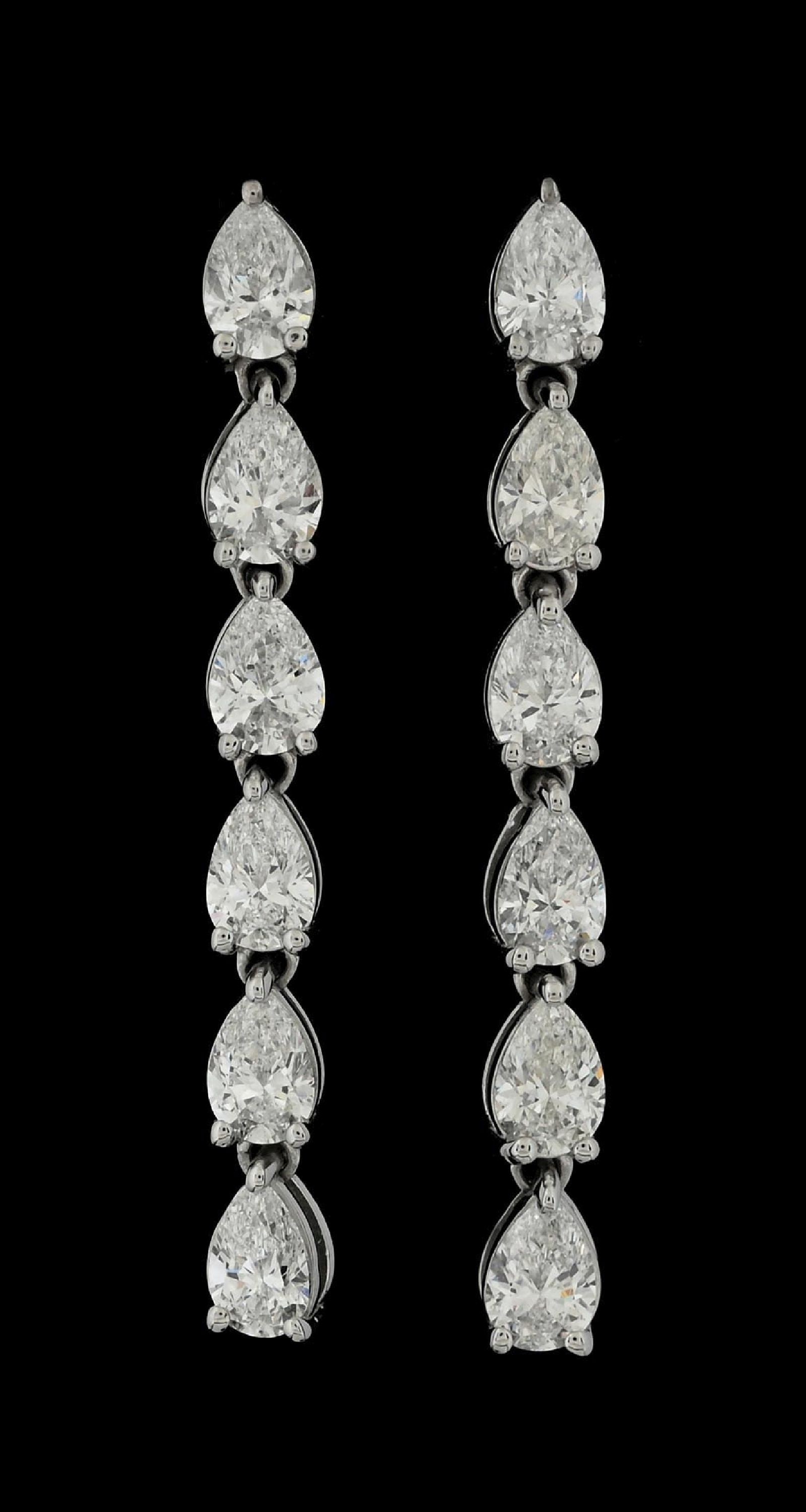PLATINUM DIAMOND DROP EARRINGS, 3.20CT TW: Platinum and diamond drop earrings consisting of 12 pear brilliant cut near-colorless natural diamonds with a total weight of 3.20cts. Length measures 1-3/8". Width measures 4mm. Gross weight is 5.0