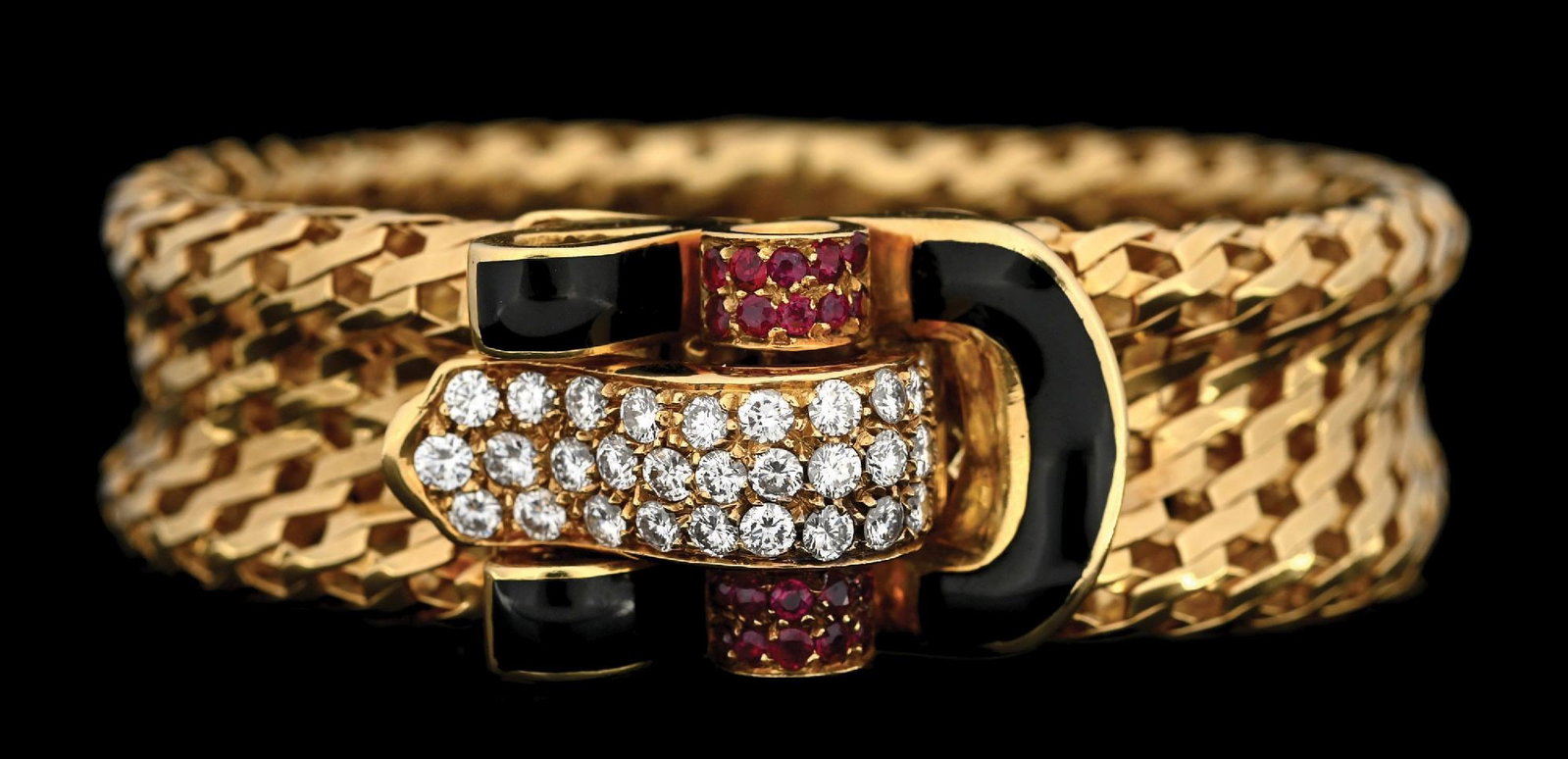 STYLE OF GUBELIN, 18K GOLD RUBY & DIAMOND ENAMELED BRACELET: 18k yellow gold designer bracelet with ruby and diamond enameled clasp in the style of Gübelin. There are a total of 31 round brilliant cut near-colorless natural diamonds with an estimated total