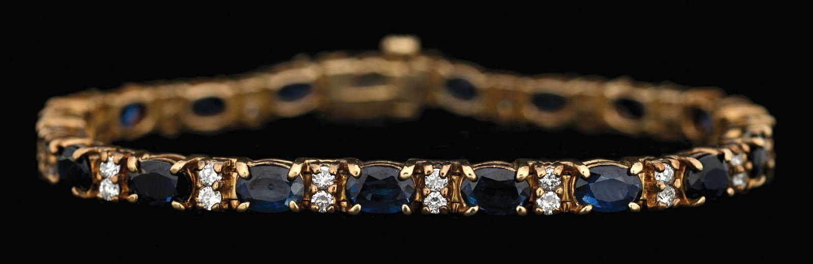 14K YELLOW GOLD SAPPHIRE & DIAMOND BRACELET: 14k yellow gold sapphire and diamond bracelet consisting of 19 oval cut natural rubies with a total weight of 11.50cts and 38 round cut near-colorless natural diamonds with a total weight of 0.75cts. 