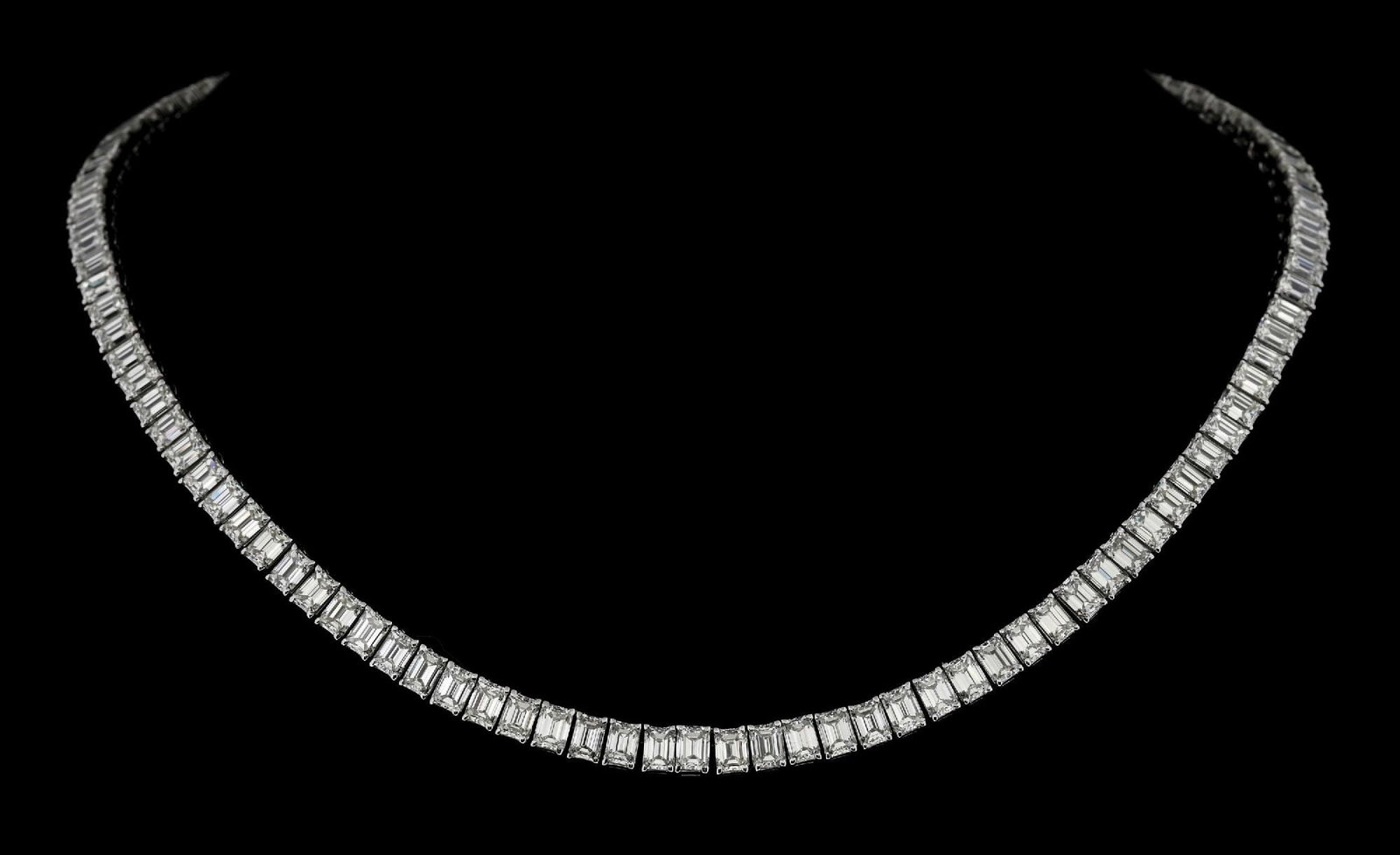 18K WHITE GOLD EMERALD CUT DIAMOND LINE NECKLACE, 34.68CT TW: 18k white gold emerald cut diamond line necklace consisting of 112 emerald cut near-colorless natural diamonds with a total weight of 34.68cts. Width measures 5.5mm. Length measures 16". Gross weight 