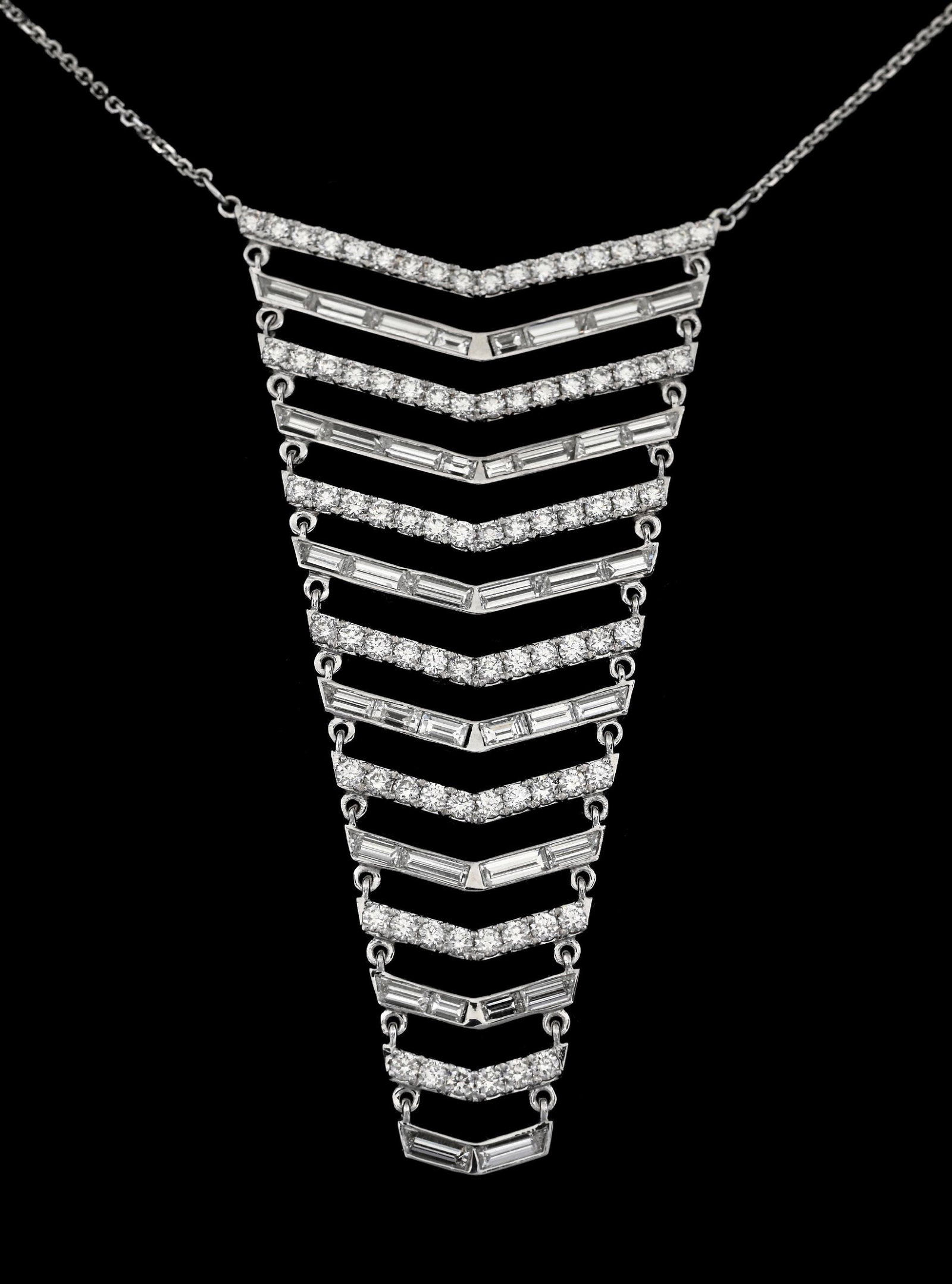 18K WHITE GOLD DESIGNER DIAMOND CHEVRON NECKLACE: 18k white gold designer diamond chevron necklace consisting of 120 mixed round brilliant cut and baguette cut natural diamonds with a combined total weight of 3.00cts. Length measures 18" plus 2" drop