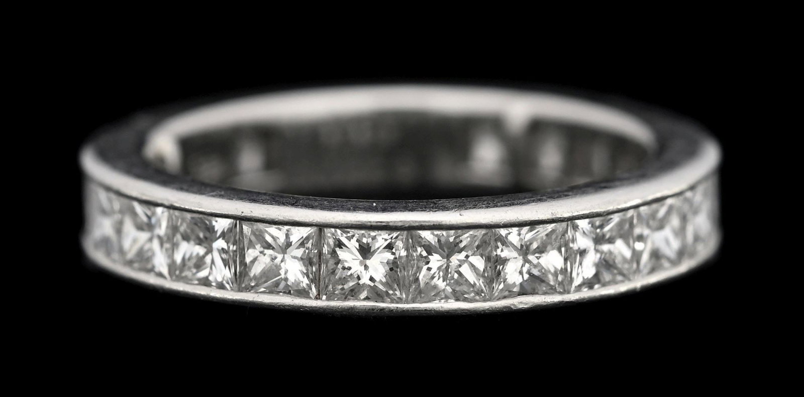 HARRY WINSTON PLATINUM 2.50CT TW DIAMOND ETERNITY BAND: Vintage platinum Harry Winston diamond eternity band consisting of 24 channel-set princess cut near-colorless natural diamonds with an estimated total weight of 2.50cts. Finger size 5, but with the ad