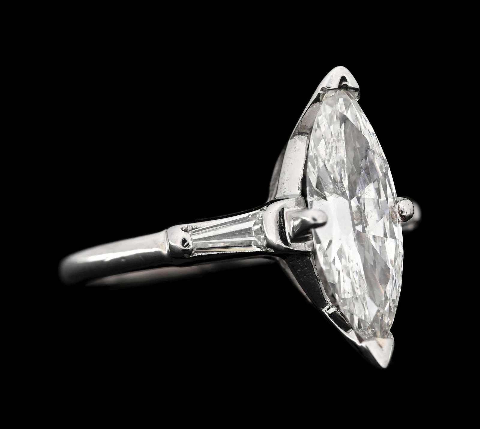 14K WHITE GOLD 1.57CT MARQUISE DIAMOND RING W/GIA REPORT: 14k white gold diamond engagement ring consisting of 1 marquise brilliant cut natural diamond weighing 1.57cts, graded H color, SI2 clarity, and 2 tapered baguette cut near-colorless natural diamonds 