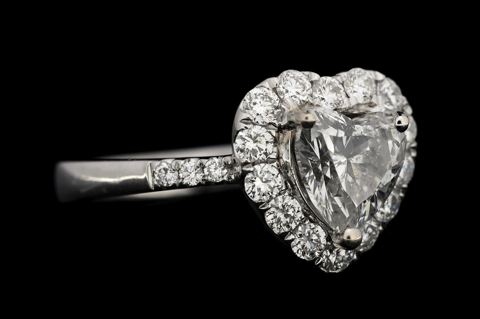 18K WHITE GOLD 1.84CT TW DIAMOND ENGAGEMENT RING W/REPORT: 18k white gold heart shape diamond (1.27ct center, 0.57ctw sides) engagement ring accompanied by an original AIGL appraisal report with an ERRV of $18,451.00. (See additional website images for