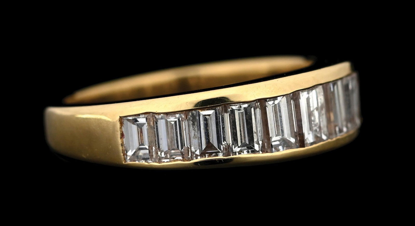 18K YELLOW GOLD BAGUETTE DIAMOND WEDDING BAND: 18k yellow gold channel set diamond wedding band consisting of 11 channel set baguette cut natural diamonds with a total weight of 1.04cts. Width at top measures 5.5mm. Finger size 5-3/4. Gross weight