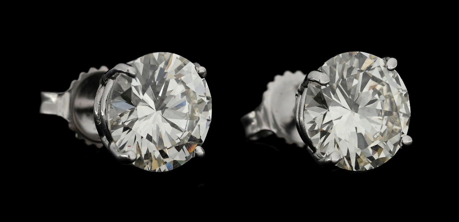 14K WHITE GOLD 4.95CT TW DIAMOND STUD EARRINGS: 14k white gold diamond stud earrings consisting of 2 round brilliant cut natural diamonds graded L color, VS1 clarity, with a total weight of 4.95cts. Diamonds are mounted in 4-prong settings with tra