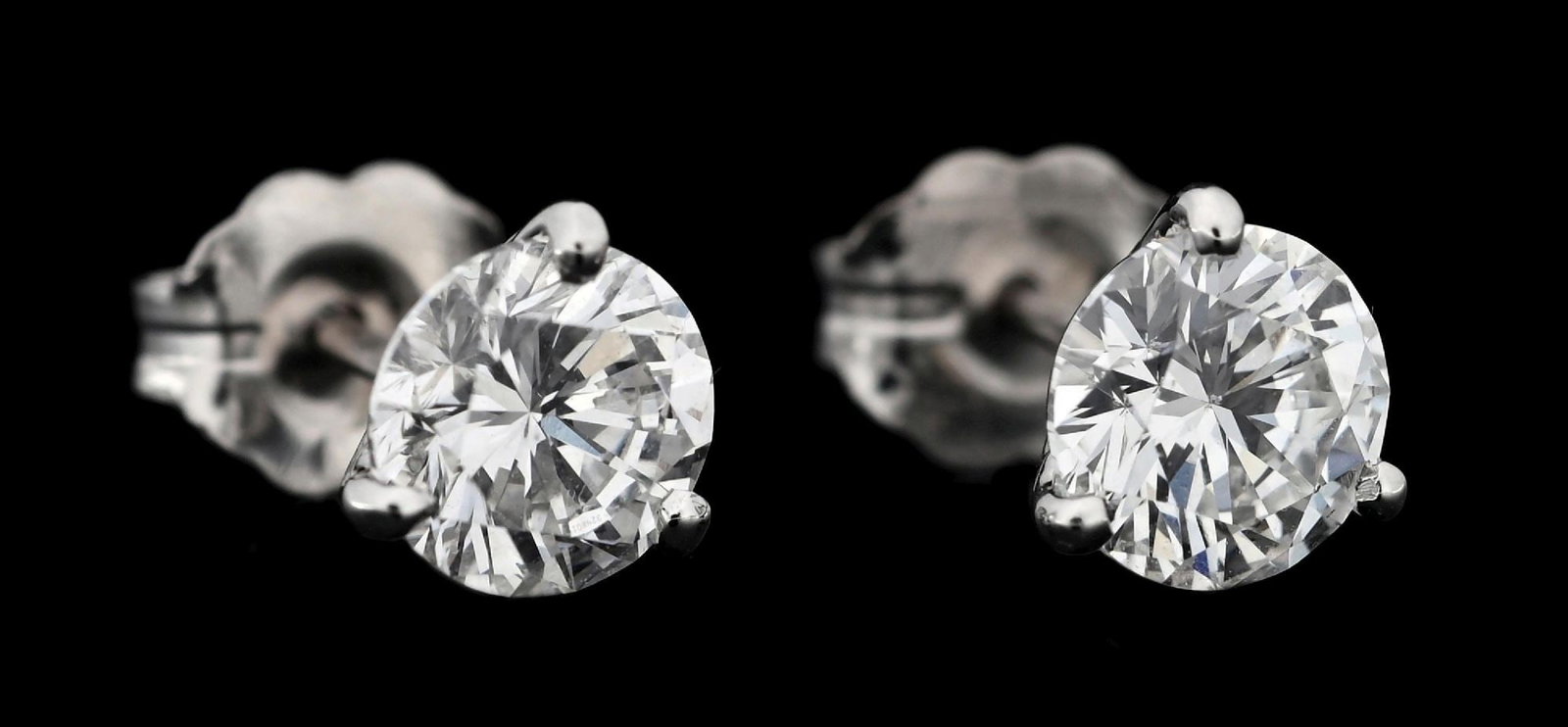 14K WHITE GOLD 1.35CT TW DIAMOND STUD EARRINGS: 14k white gold diamond stud earrings consisting of 2 round brilliant cut near-colorless natural diamonds with a total weight of 1.35cts. Diamonds are mounted in 3-prong "martini glass" settings with t