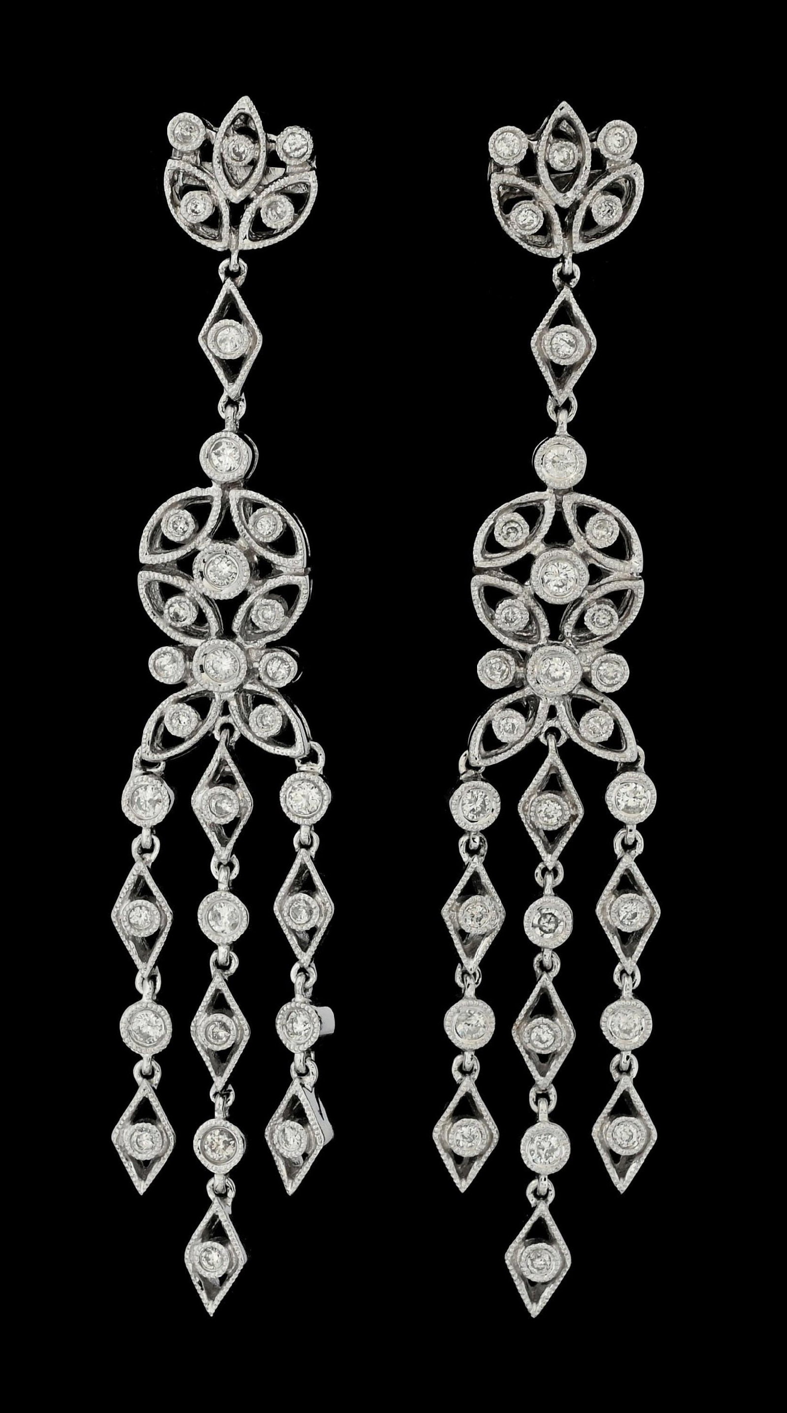 18K WHITE GOLD DIAMOND CHANDELIER DROP EARRINGS: 18k white gold diamond chandelier drop earrings consisting of 60 round brilliant cut near-colorless natural diamonds with a total weight of 1.25cts. Length measures 2-5/8". Width measures 10mm. Gross 