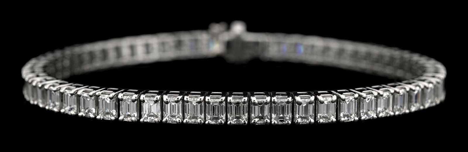 PLATINUM EMERALD CUT DIAMOND BRACELET, 10.84CT TW: Platinum and diamond bracelet consisting of 58 emerald cut near-colorless natural diamonds with a total weight of 10.84cts. Length measures 7-1/8". Width measures 4.5mm. Gross weight is 30.0 grams. Ma
