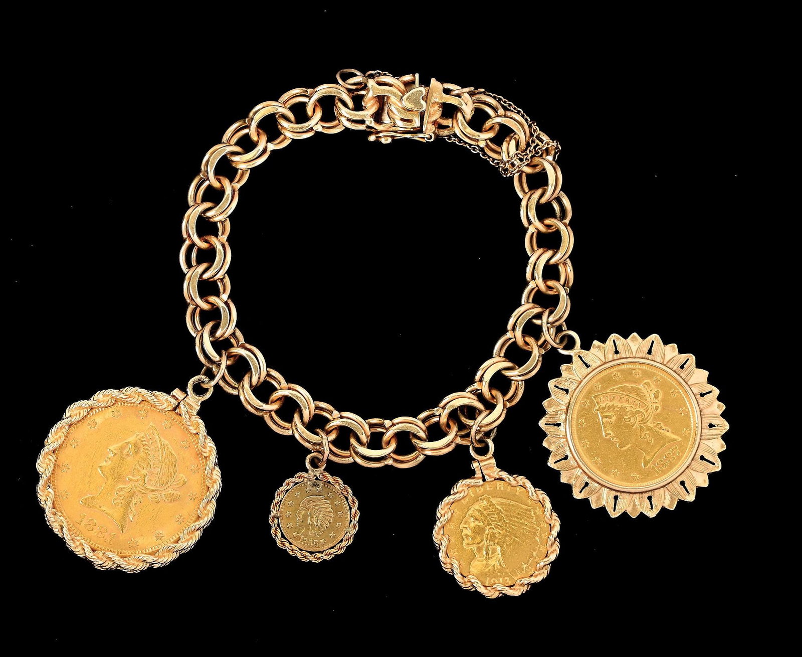 14K GOLD CHARM BRACELET W/4 GOLD COINS: Ladies' 14k yellow gold heavy double-link charm bracelet with 4 gold coins. Coins include an 1881-S $10 Eagle, 1887-S $5 Half Eagle, 1913 $2.5 Indian and an 1855 California Gold replica "1/2" coin. Le