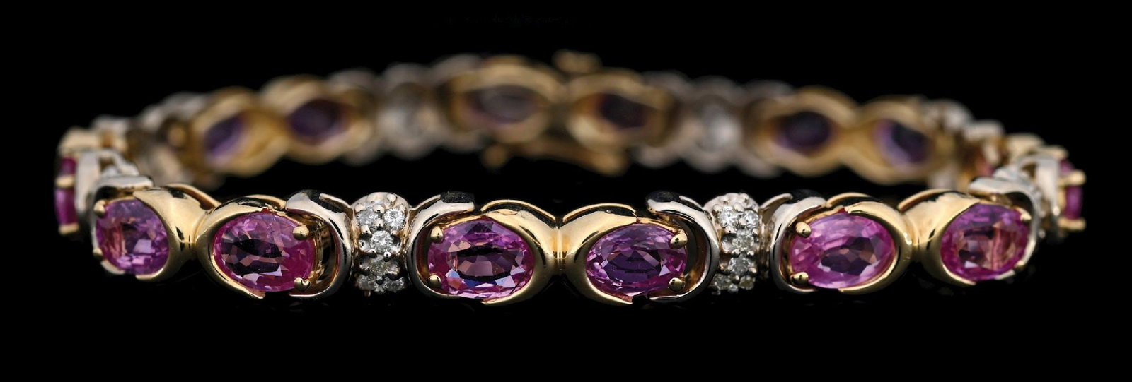 14K T/T GOLD PINK SAPPHIRE & DIAMOND BRACELET W/REPORT: 14k yellow and white gold pink sapphire (16.00ctw) and diamond (0.75ctw) bracelet accompanied by an original GGA appraisal report with an ERRV of $35,290.00. (See additional website images for report 