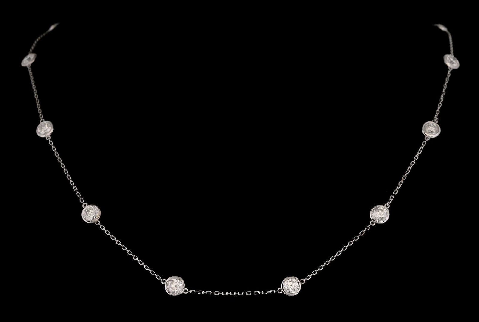 14K WHITE GOLD DIAMOND STATION NECKLACE W/REPORT: 14k white gold diamond (3.73ctw) station necklace accompanied by an original GGA appraisal report with an ERRV of $17,340.00. (See additional website images for report specifications). Length measures
